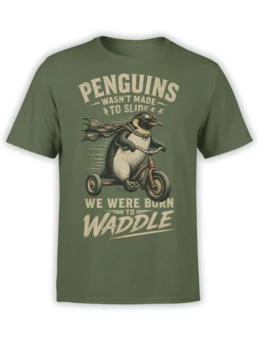 Green penguin T-shirt with a caped penguin riding a tricycle and bold cream lettering about waddling