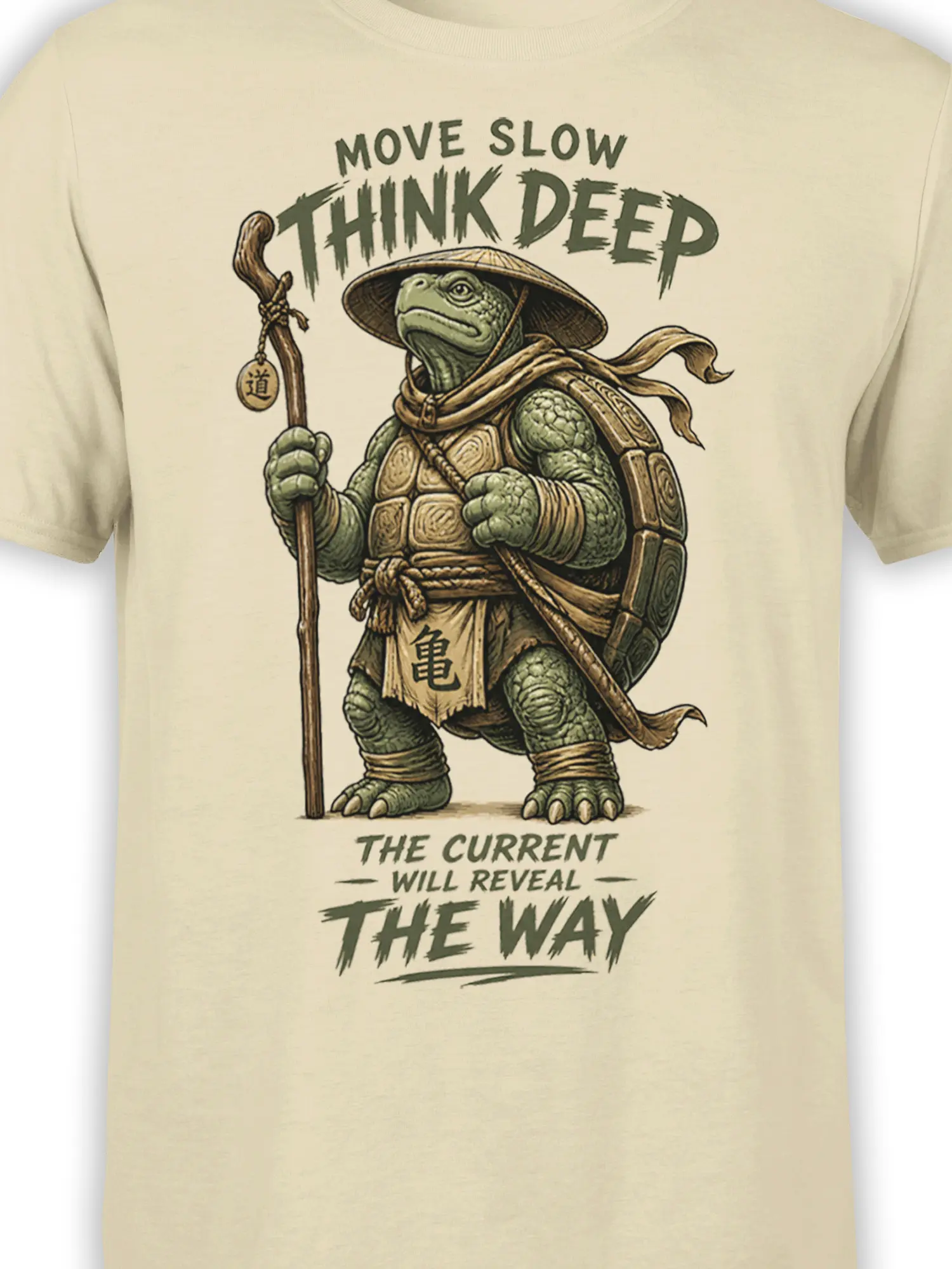 Close-up of turtle traveler artwork, shell armor, staff, and deep-thinking text on a beige T-shirt