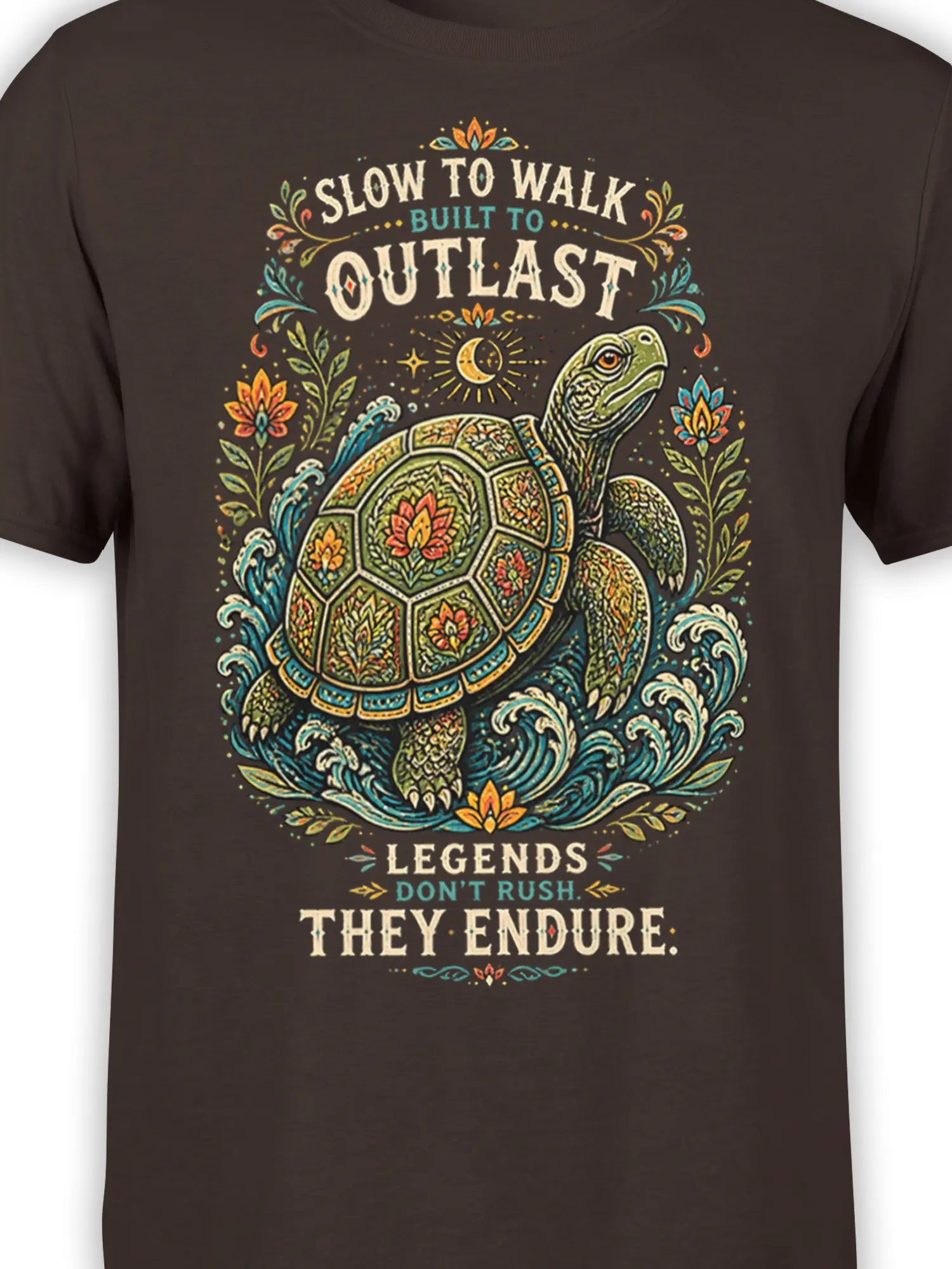 Close-up of the floral turtle graphic, ocean waves, moon, and endurance lettering on a brown T-shirt