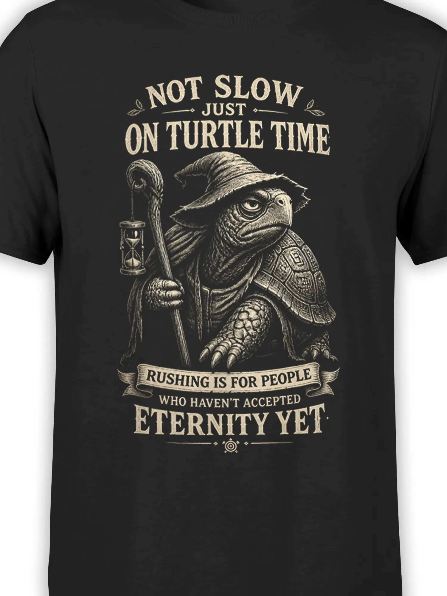 Close-up of the wizard turtle artwork, pointed hat, hourglass, staff, and cream vintage lettering on black