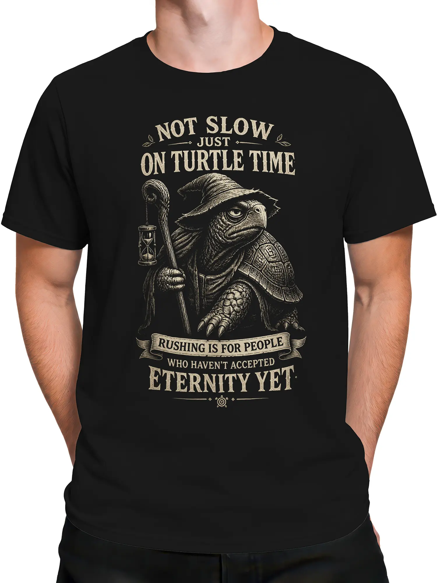 Male torso wearing a black wizard turtle T-shirt with vintage artwork and an unhurried time quote