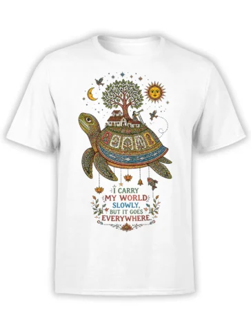 White turtle T-shirt with a colorful village, tree, sun, moon, and slow-living quote
