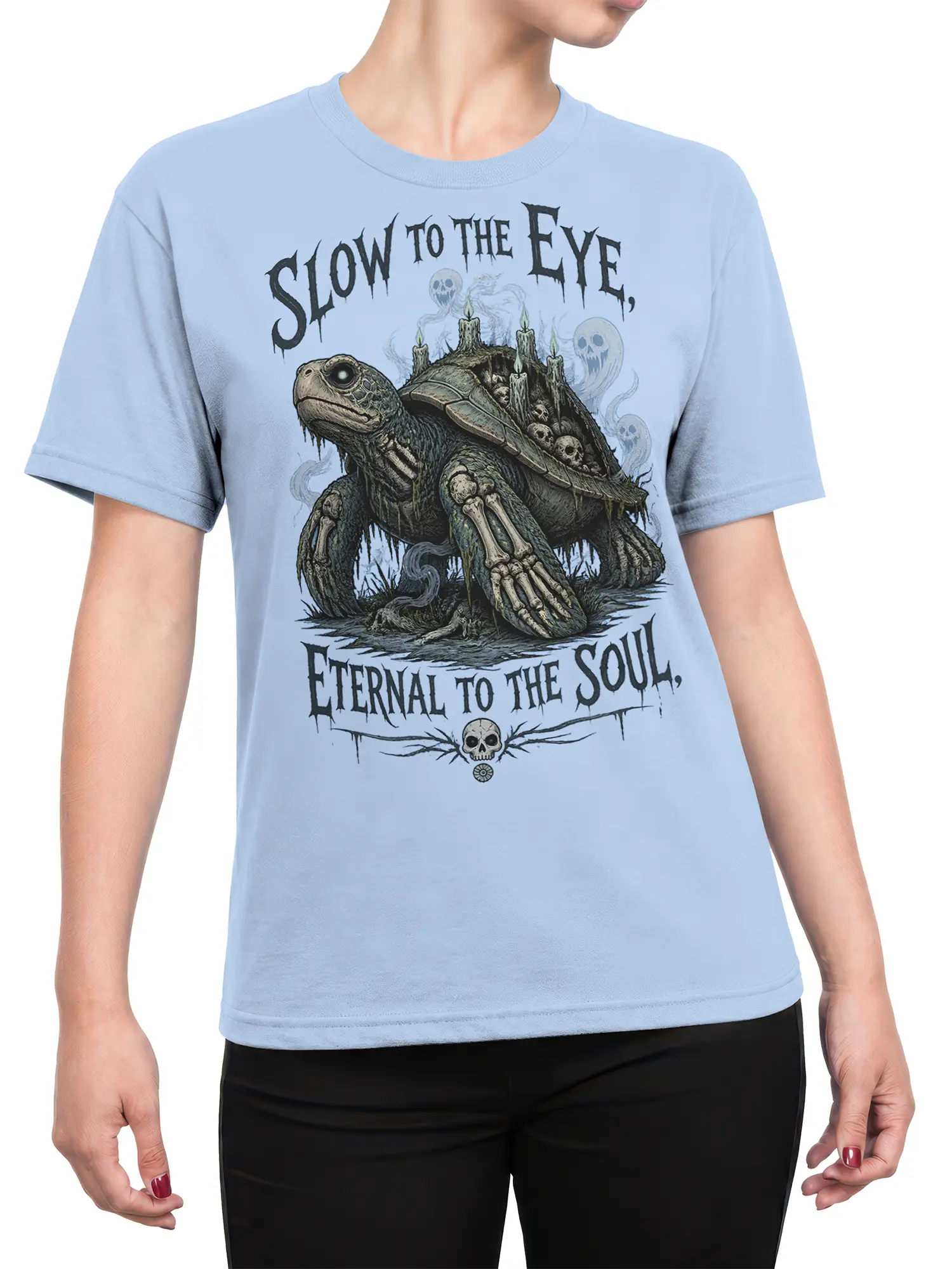 Female torso wearing a light blue T-shirt with a haunted turtle, candles, skulls, and ghostly artwork