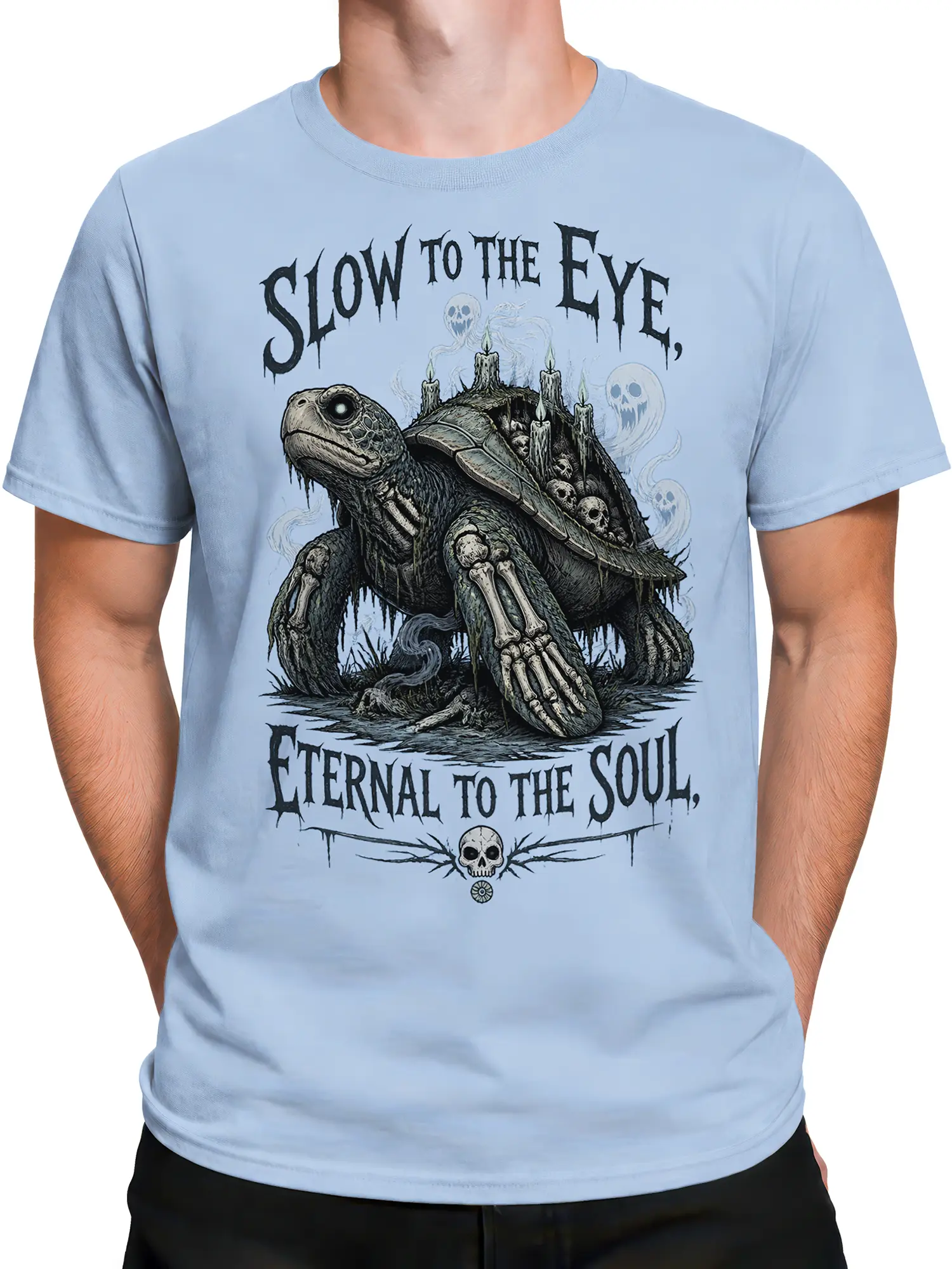 Male torso wearing a light blue haunted turtle T-shirt with skulls, candles, ghosts, and gothic lettering