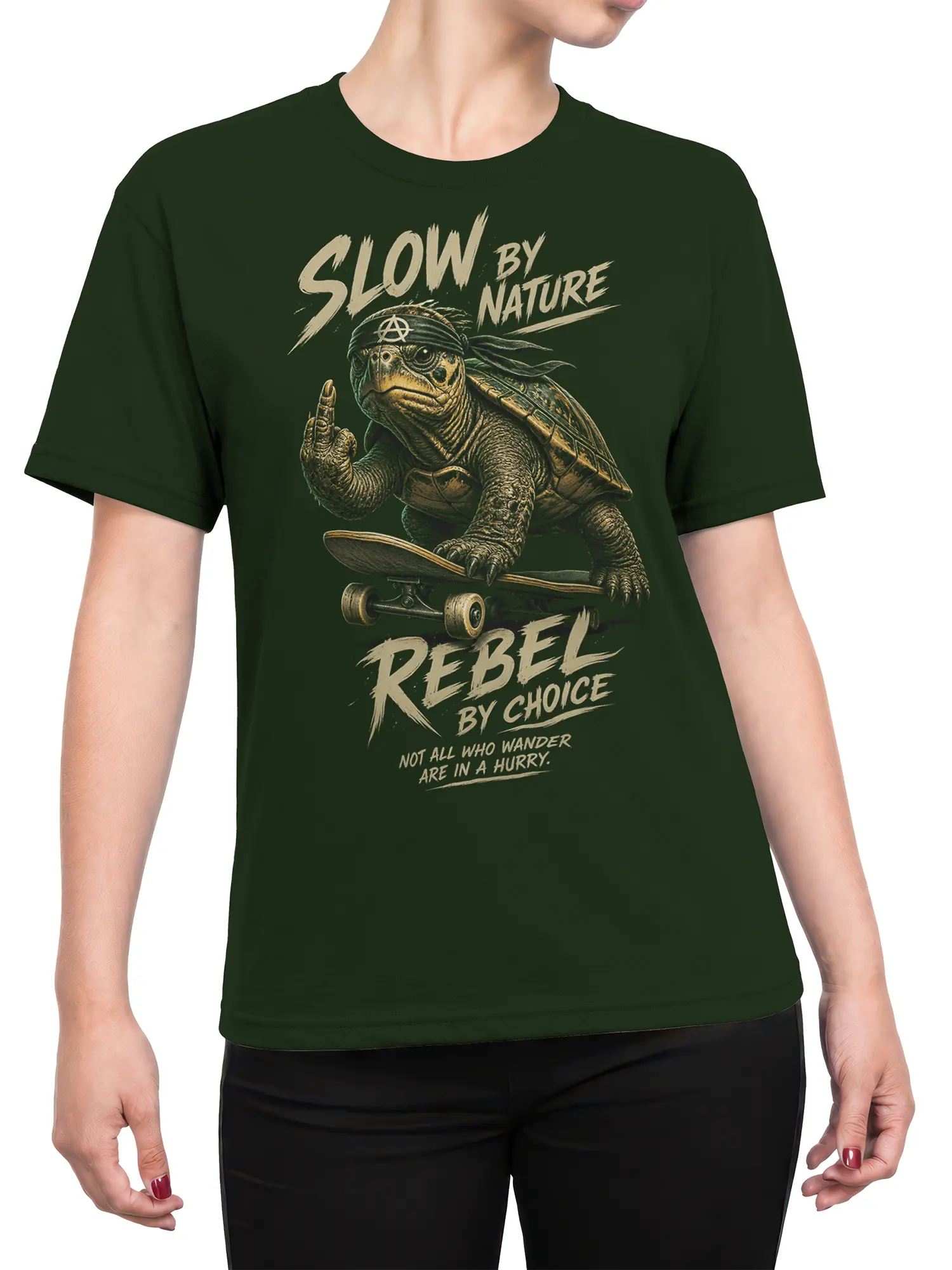 Female torso wearing a green T-shirt with a skateboarding turtle and bold slow-living rebel graphic