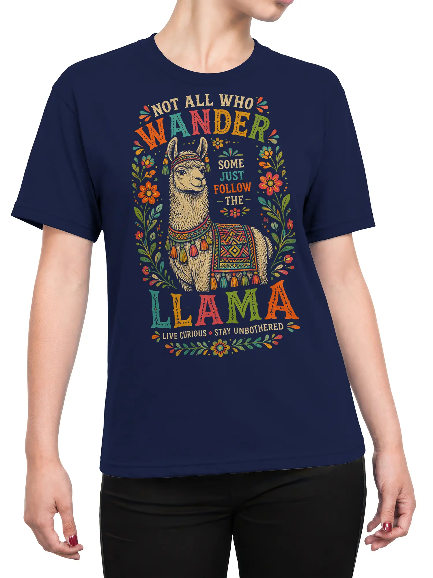 Female torso wearing a navy llama T-shirt with colorful folk-art flowers and a curious wanderer message