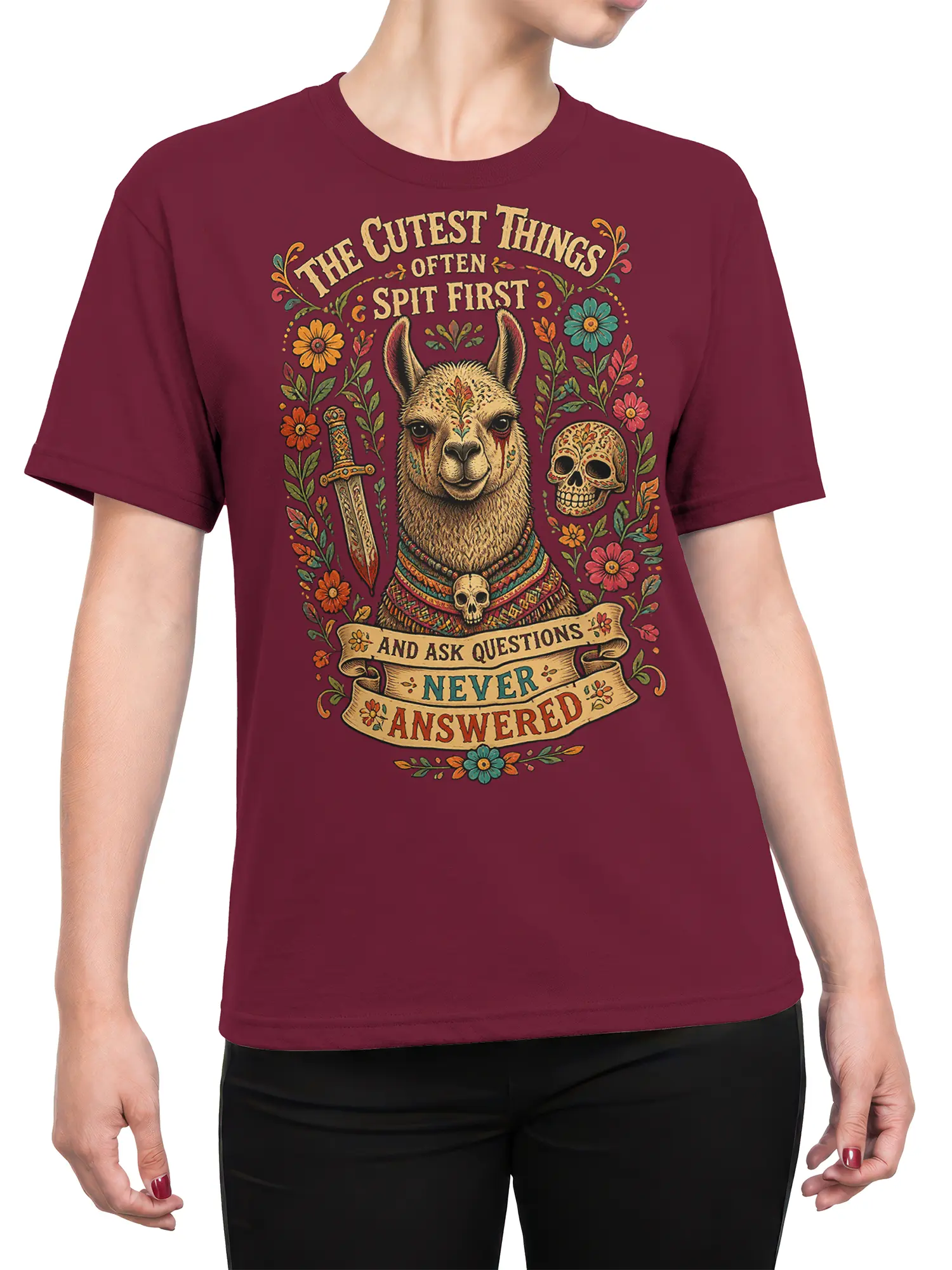 Female torso wearing a burgundy llama T-shirt with colorful floral artwork, skulls, sword, and vintage lettering