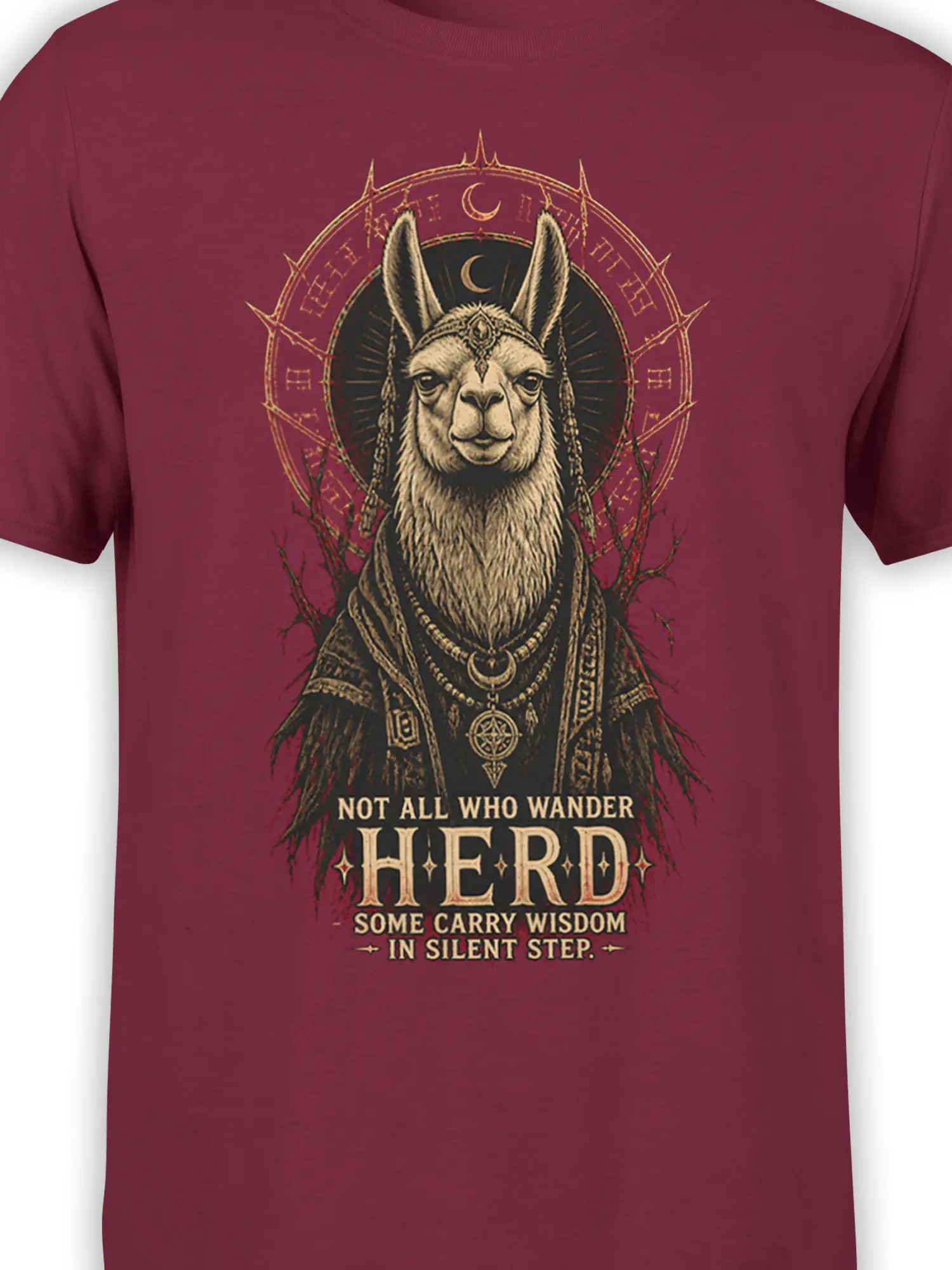 Close-up of robed llama artwork, moon symbols, and wisdom lettering on a burgundy T-shirt