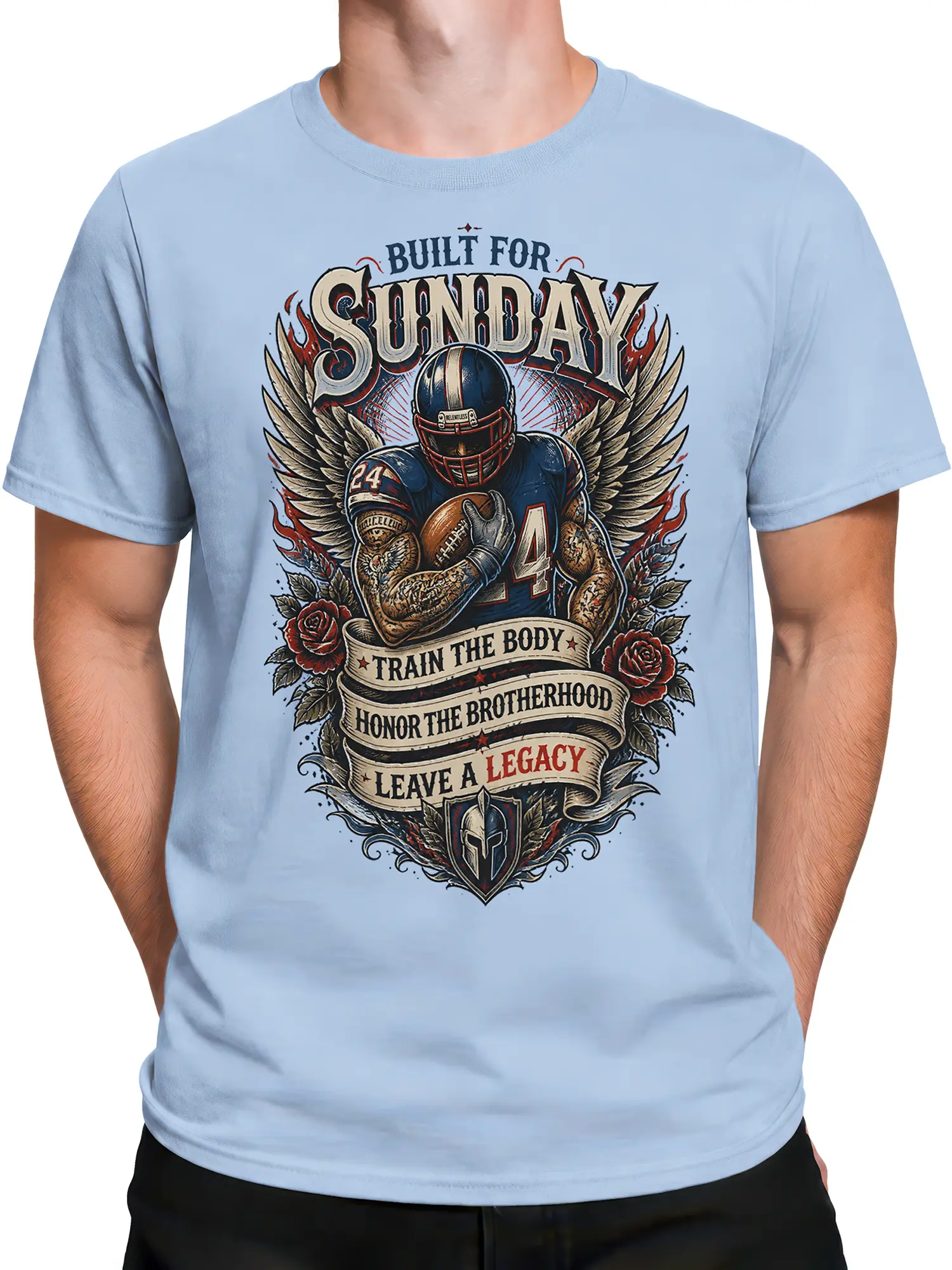 Male torso wearing a light blue Sunday Legacy football T-shirt with wings, roses, and shield artwork