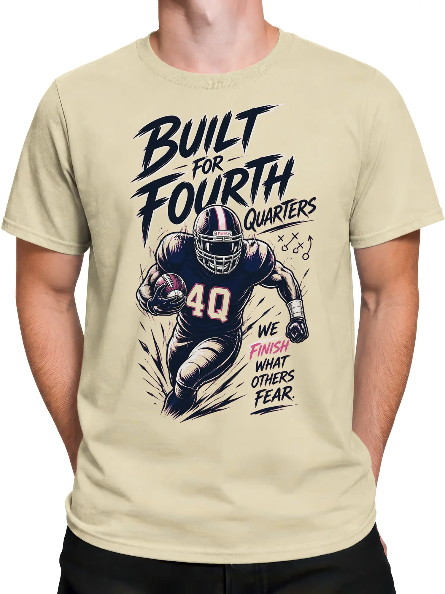 Male torso wearing beige American football T-shirt with helmeted player and determined game-day artwork