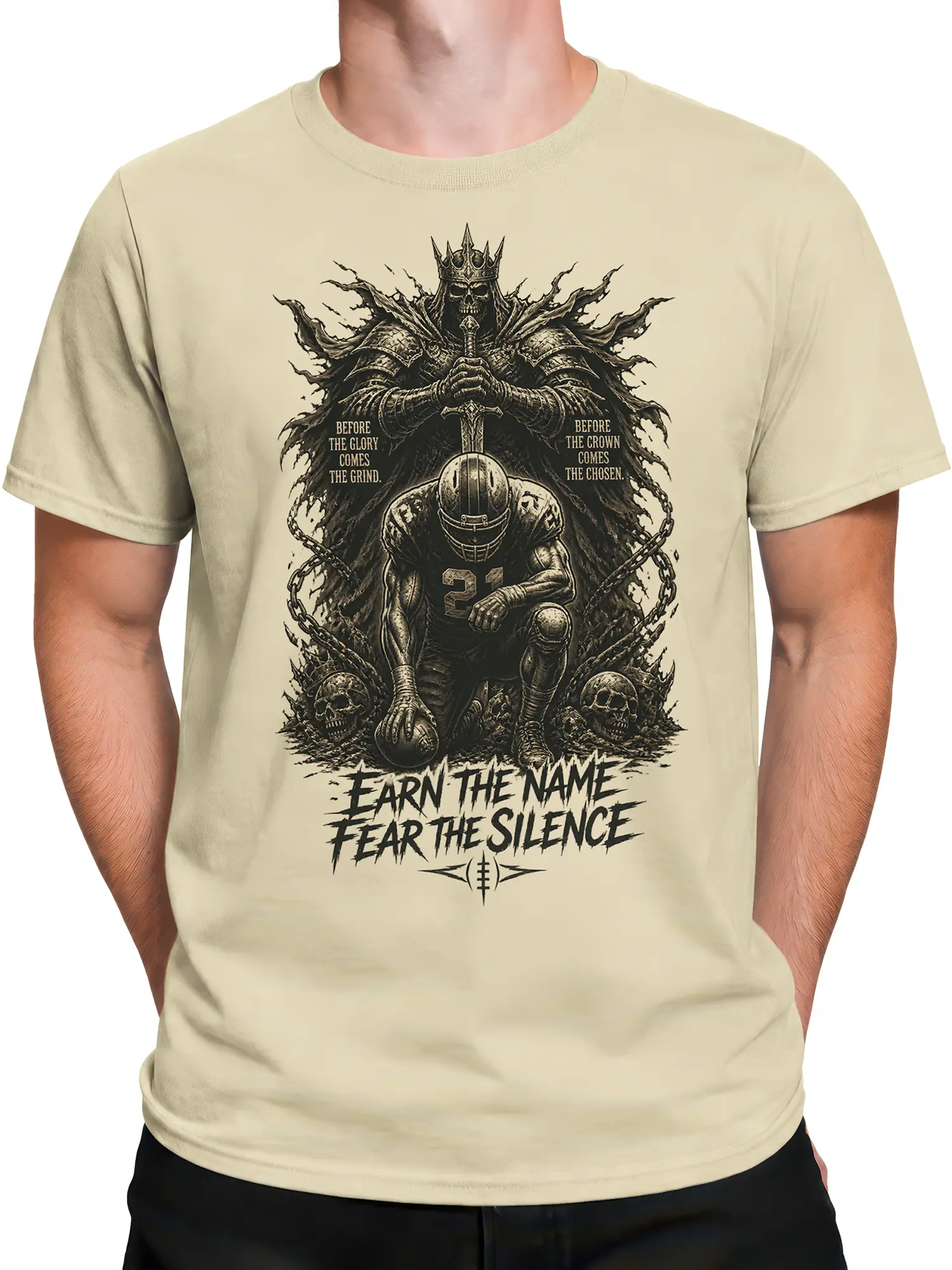 Male torso wearing a beige T-shirt with crowned skeleton king football artwork