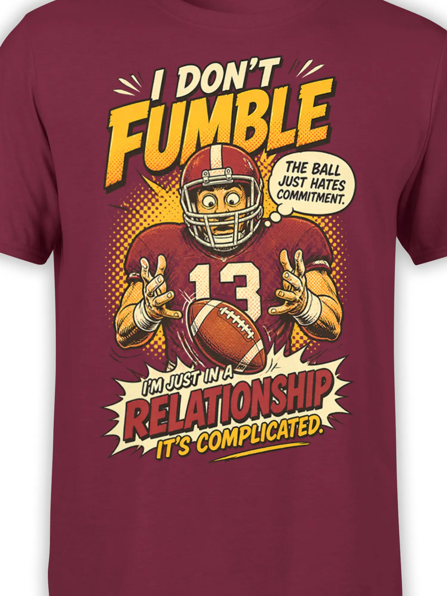 Close-up of number 13 football player and commitment joke artwork on a burgundy graphic tee