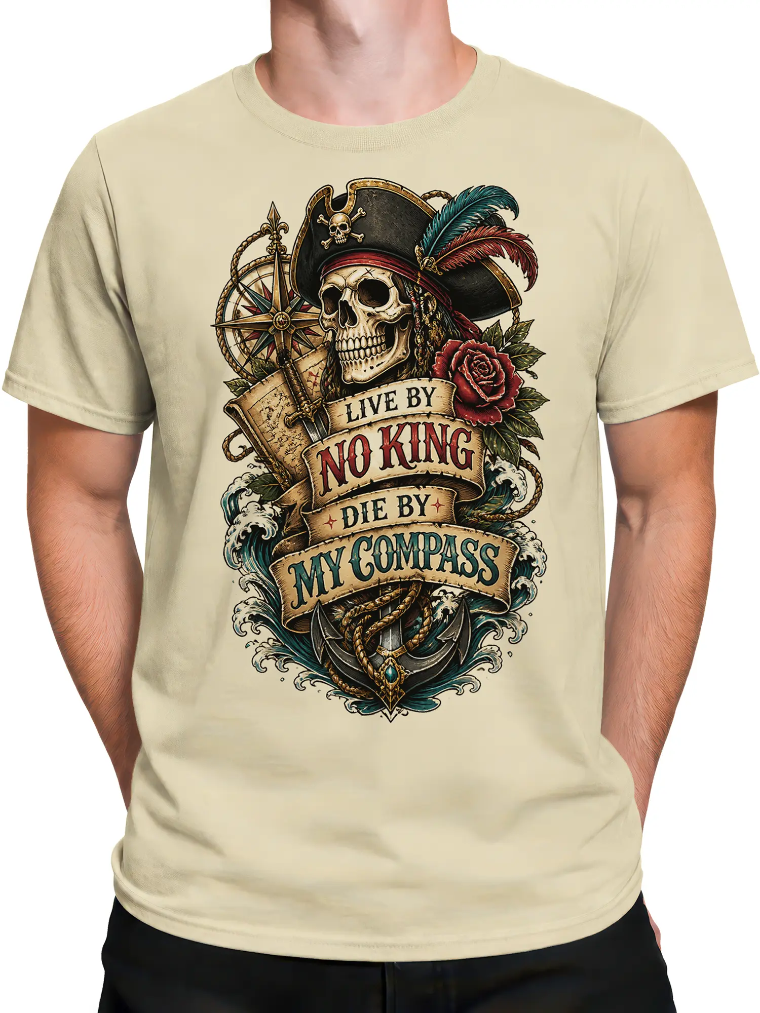 Male torso wearing a beige pirate T-shirt with skull, compass, anchor, waves, rose, and vintage banner artwork