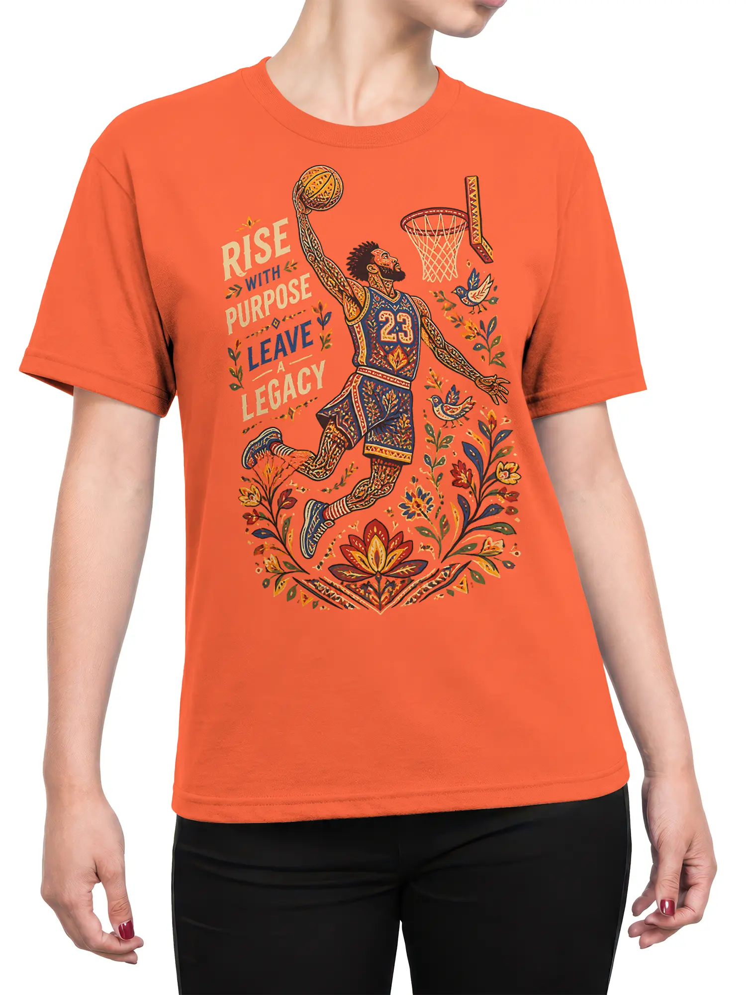 Female torso wearing an orange T-shirt with ornate basketball player, floral, bird, and legacy artwork