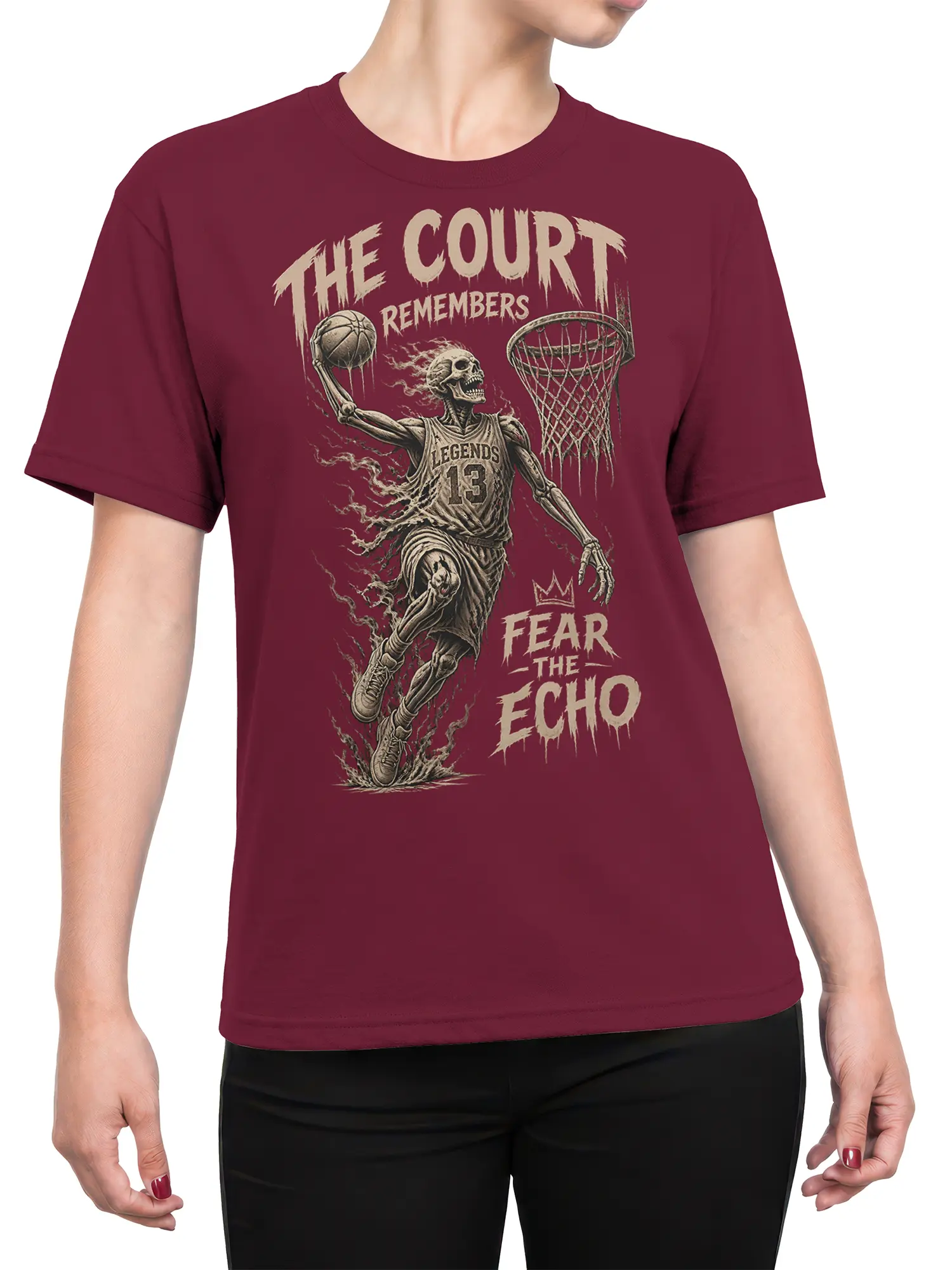 Female torso wearing a burgundy skeleton basketball T-shirt with haunted court artwork and cream distressed lettering