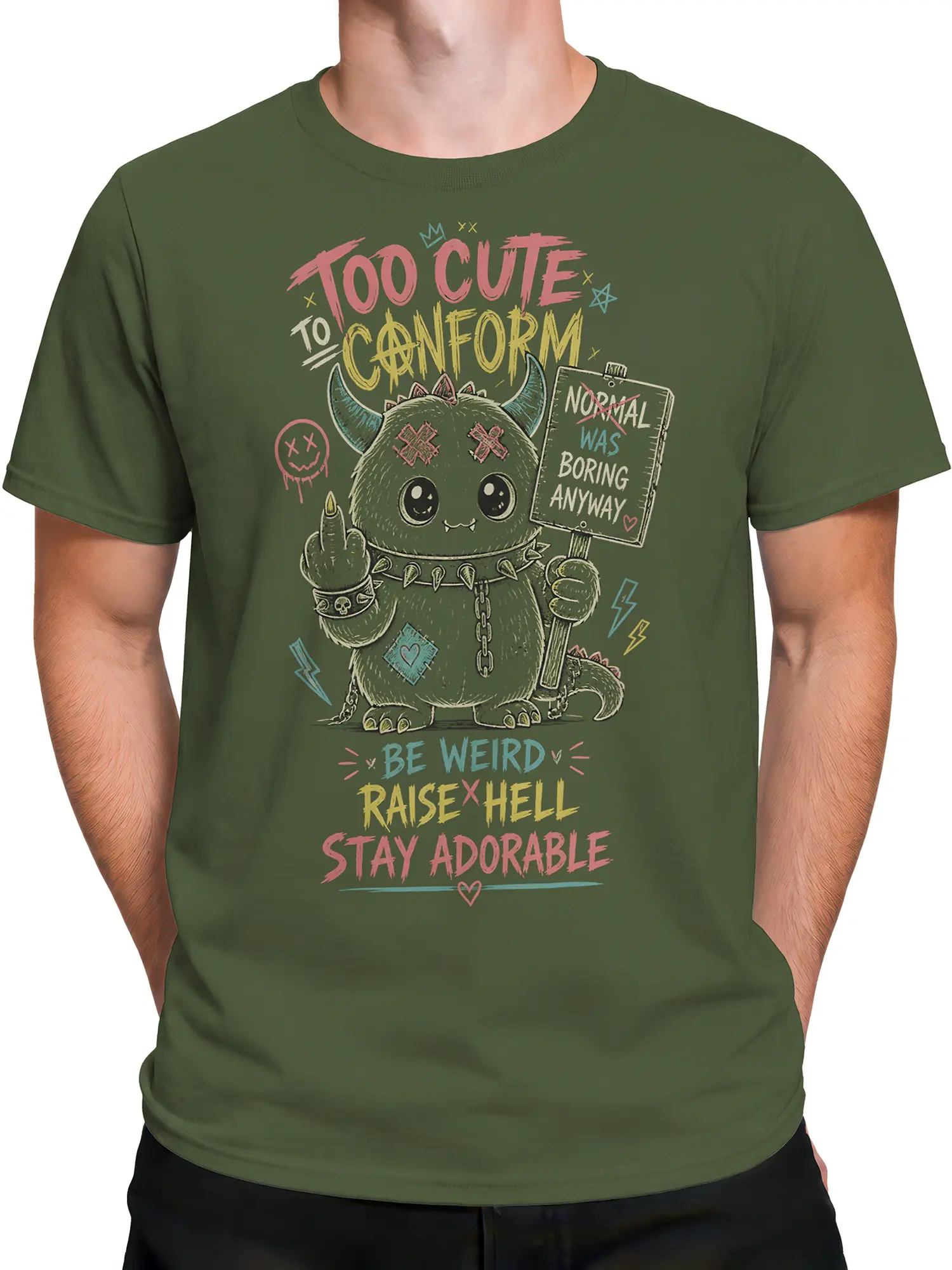 Male torso wearing an olive green T-shirt with a cute horned monster graphic and colorful rebellious text