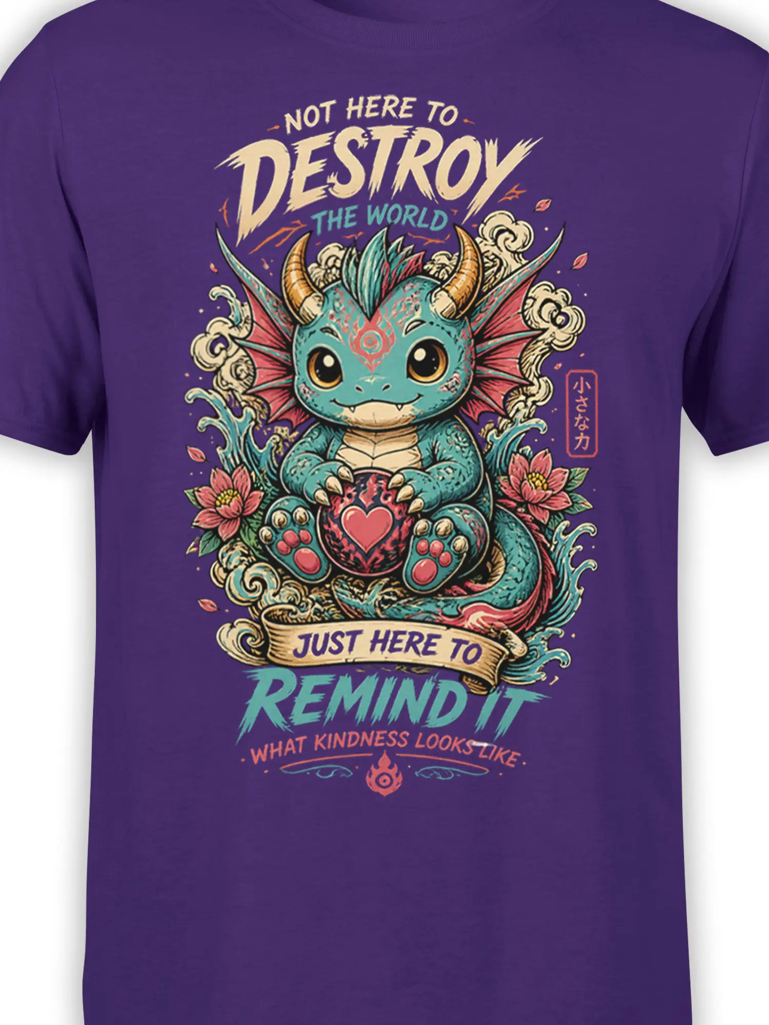 Close-up of the teal horned dragon, heart, lotus flowers, and kindness artwork on a purple T-shirt