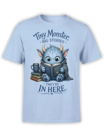 Light blue T-shirt with a blue horned monster reading a book beside coffee and stacked books