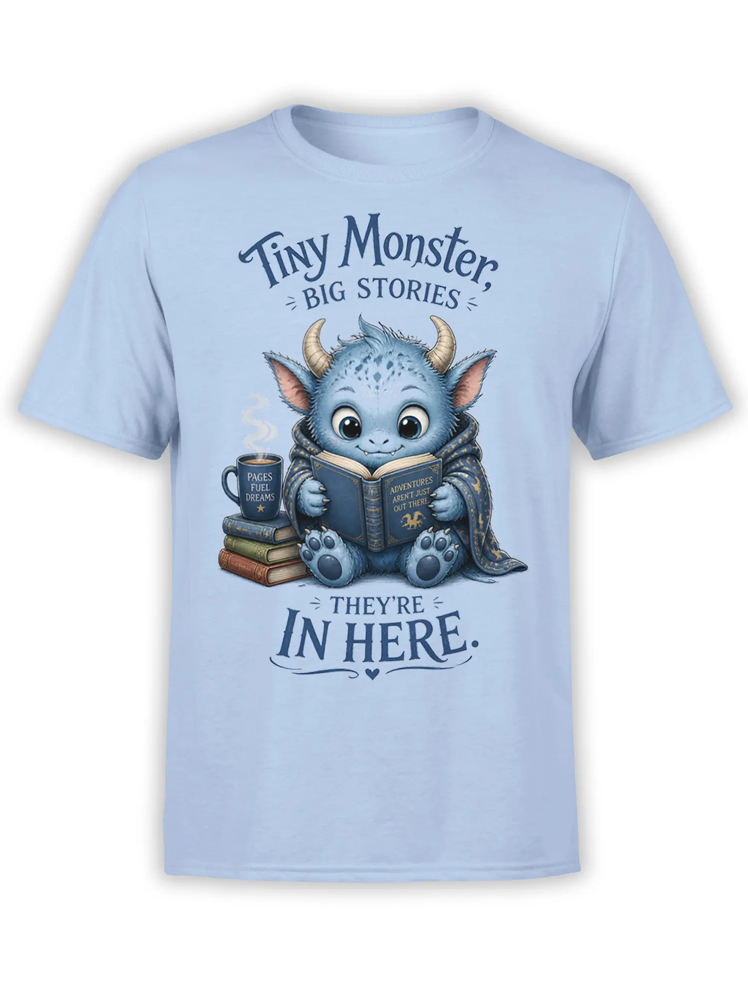Light blue T-shirt with a blue horned monster reading a book beside coffee and stacked books