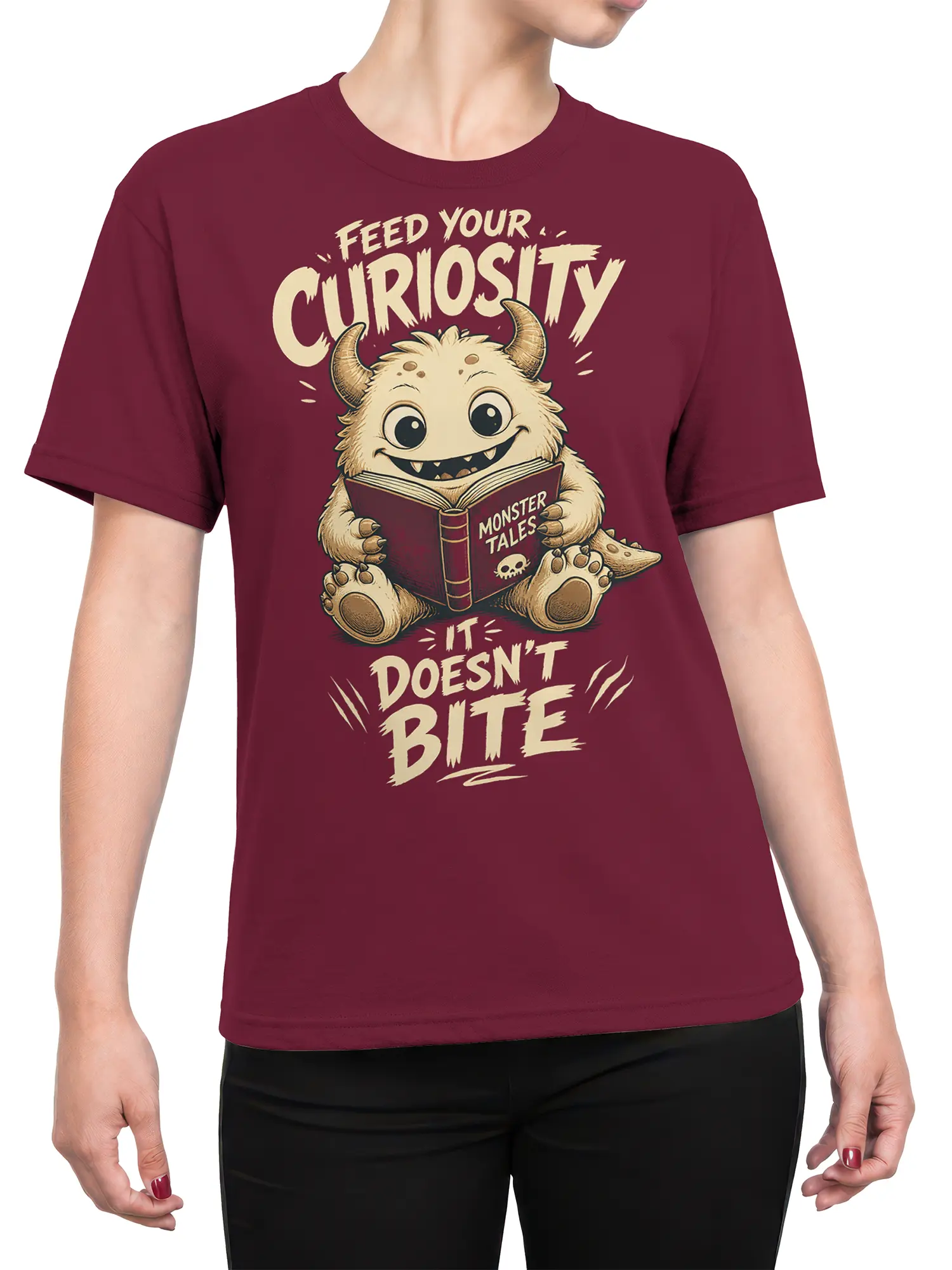 Female torso wearing a burgundy T-shirt with a whimsical monster reading graphic and curiosity slogan