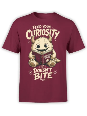 Whimsical horned monster reading a book on a burgundy T-shirt with “Feed Your Curiosity” lettering