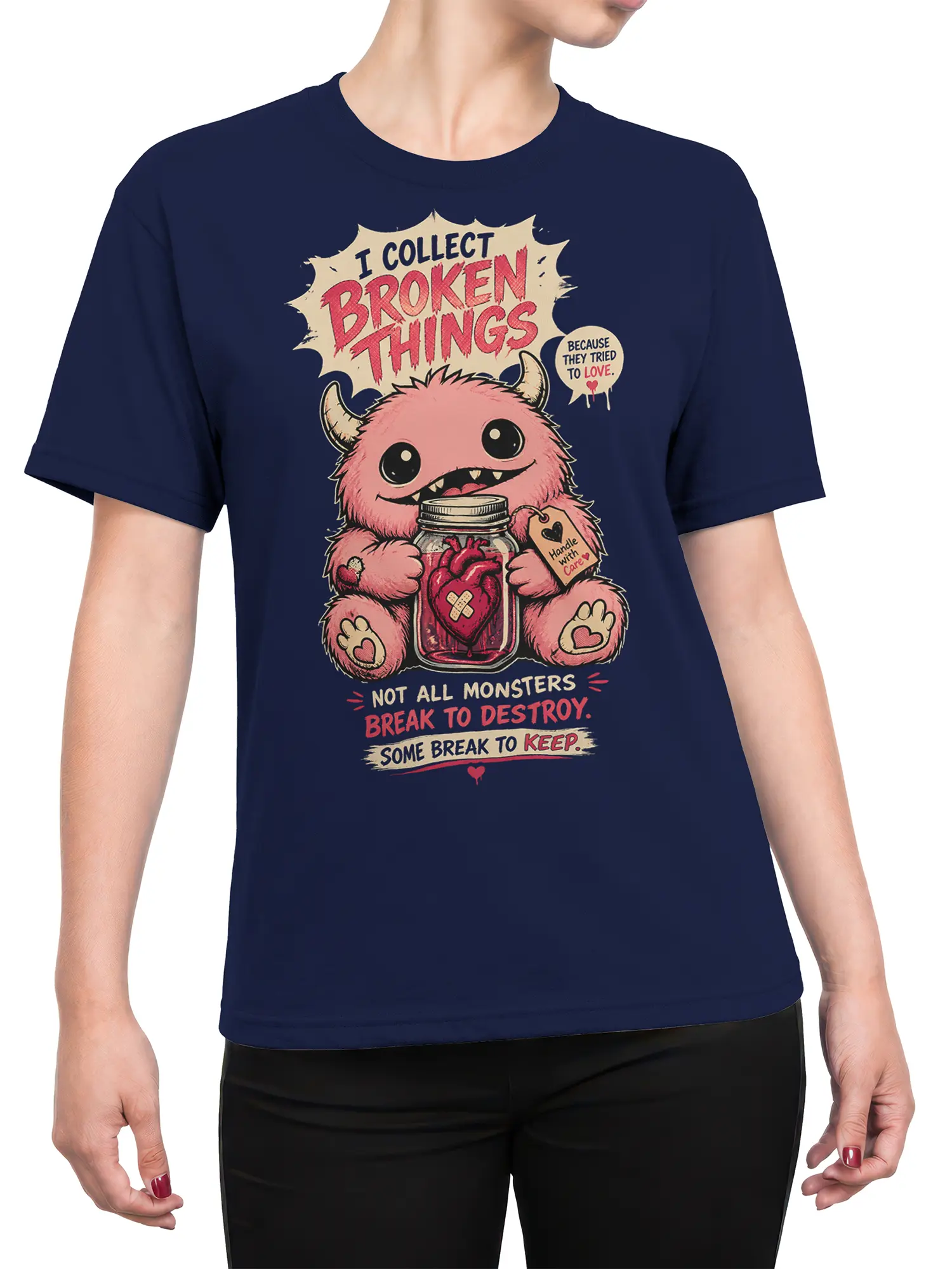 Female torso wearing a navy T-shirt with a pink monster and broken heart jar design