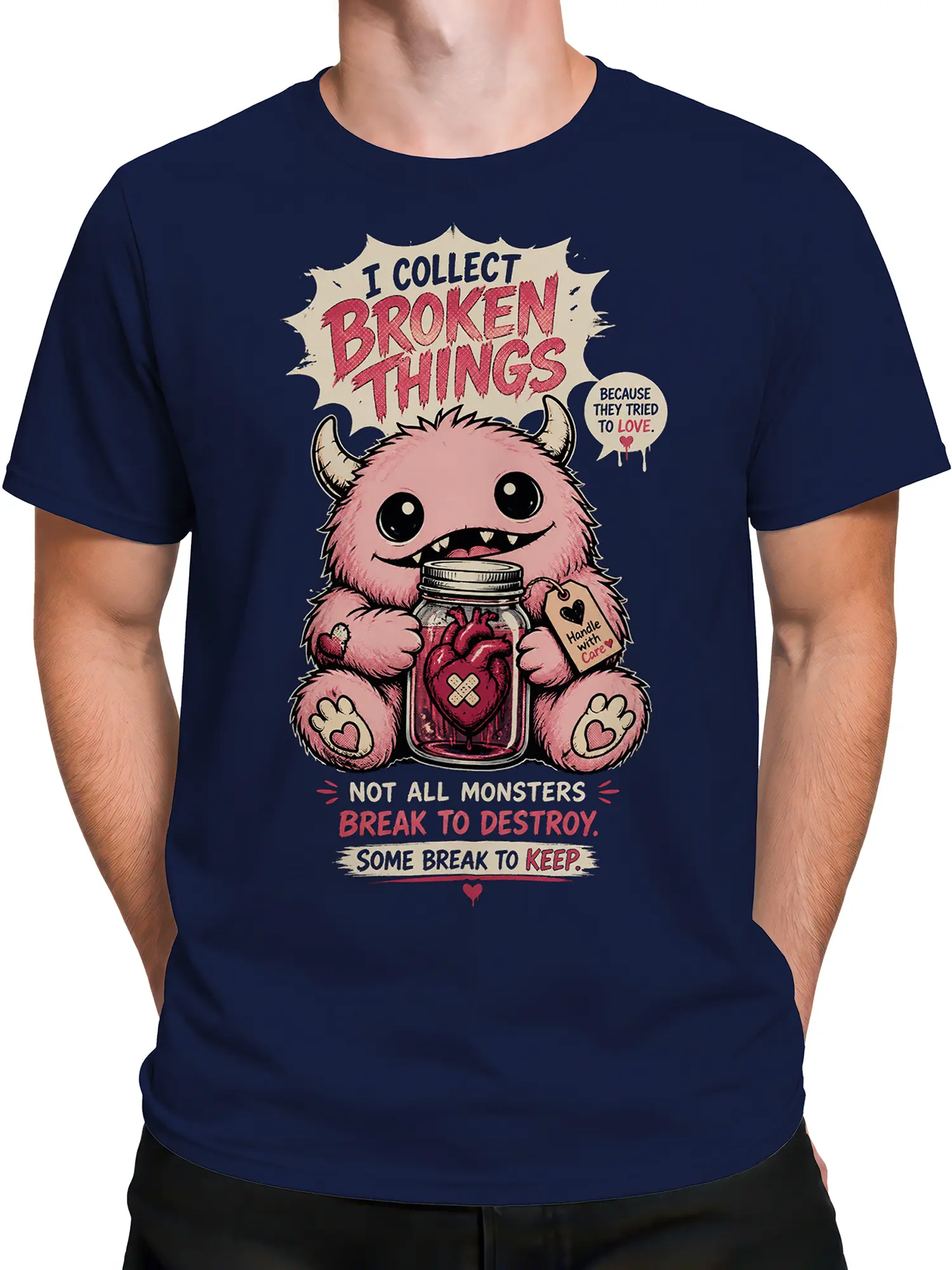 Male torso wearing a navy monster T-shirt with a tender broken-heart illustration