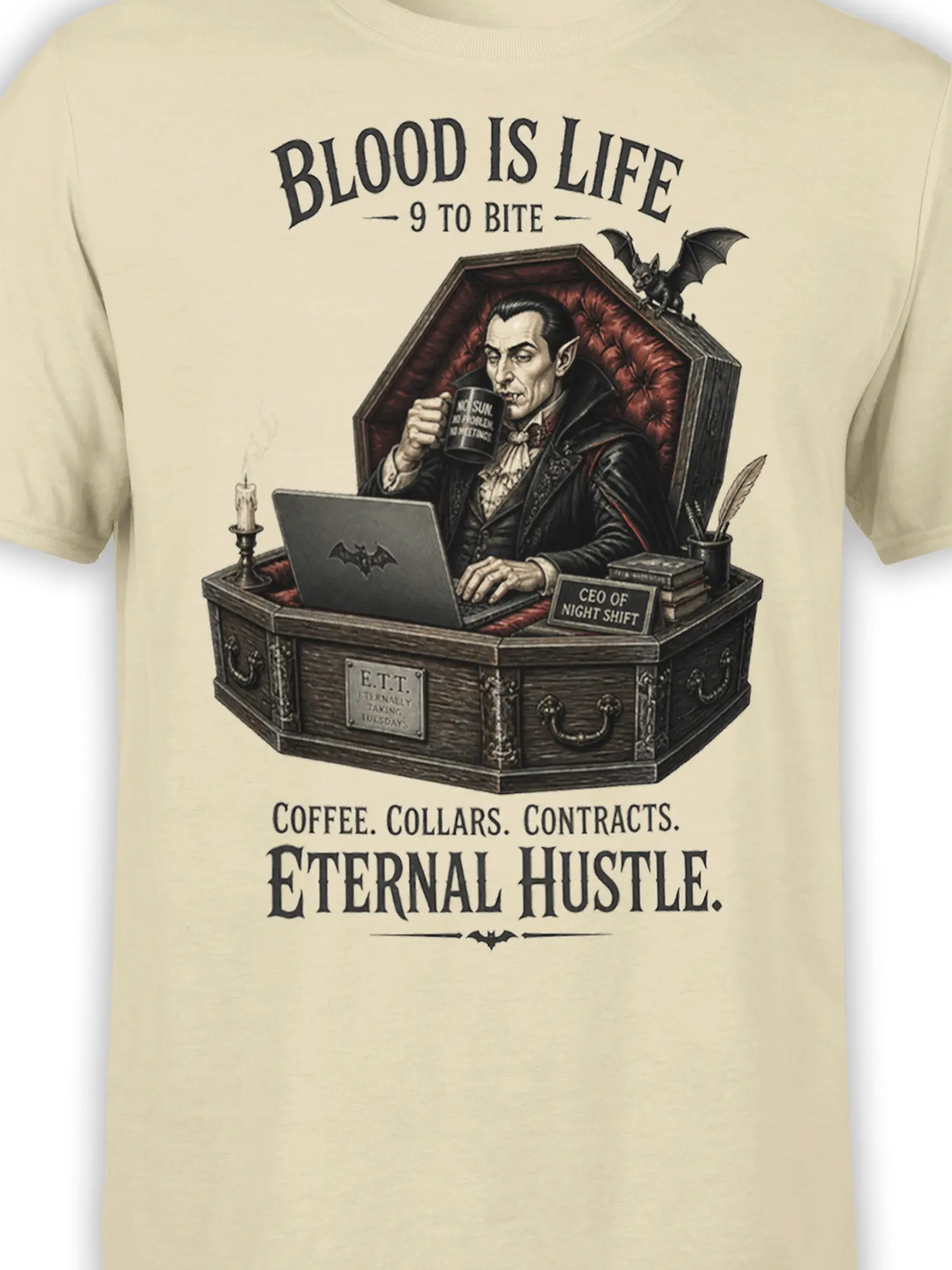 Close-up of vampire office artwork on a beige shirt with coffin desk, coffee mug, laptop, and bat details