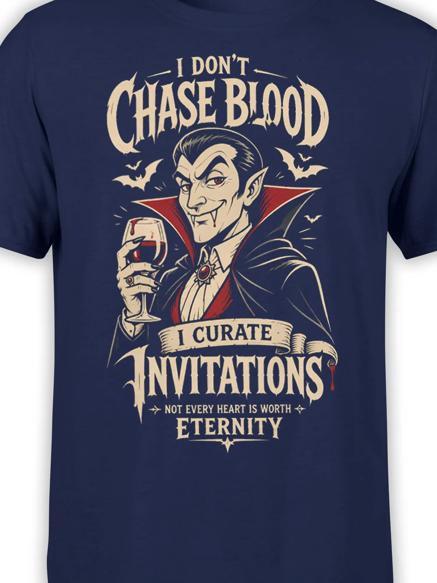 Close-up of vampire artwork, bats, and gothic lettering printed on a navy T-shirt