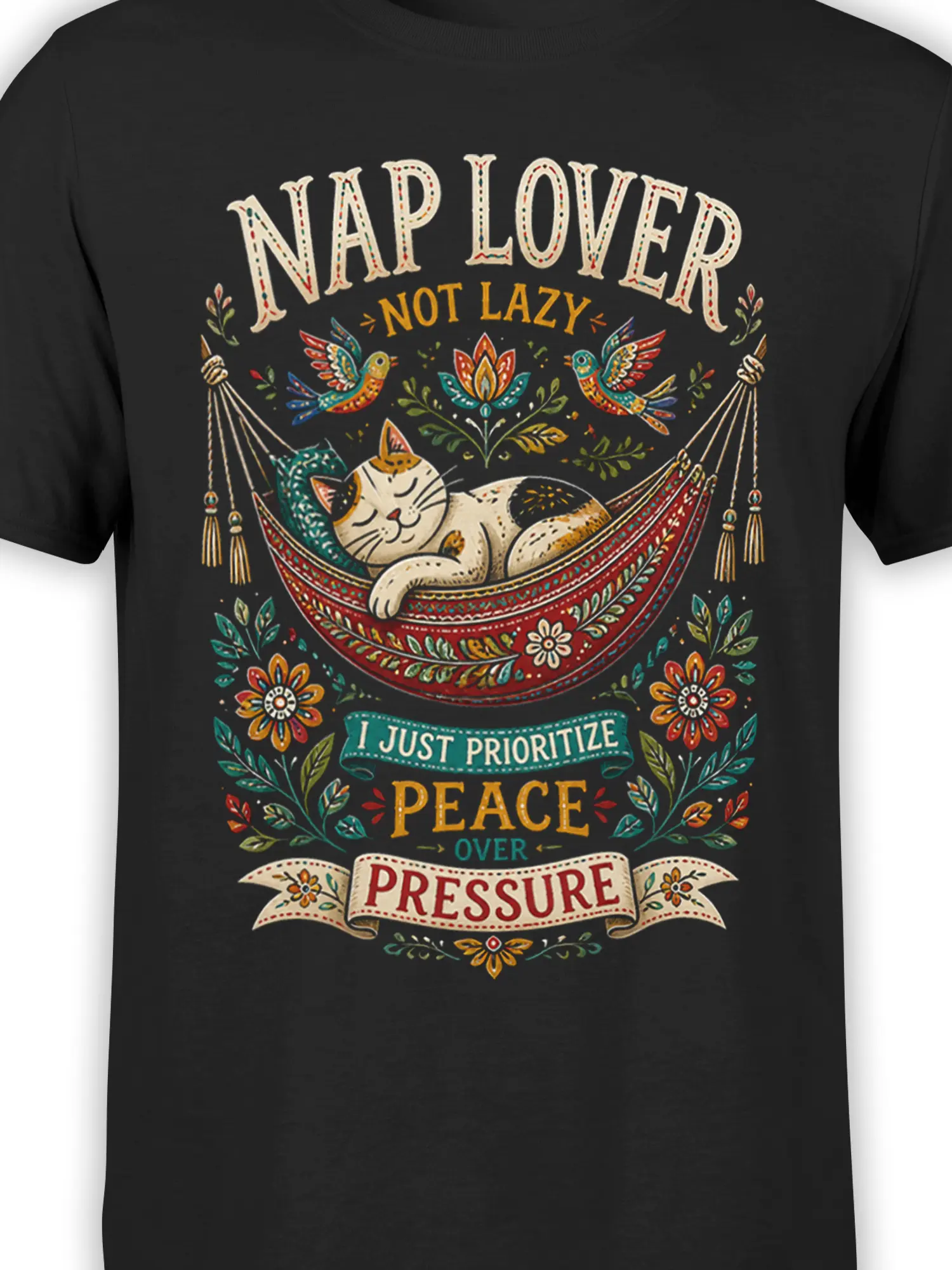 Close-up of the sleeping cat hammock design with colorful folk art details on a black T-shirt