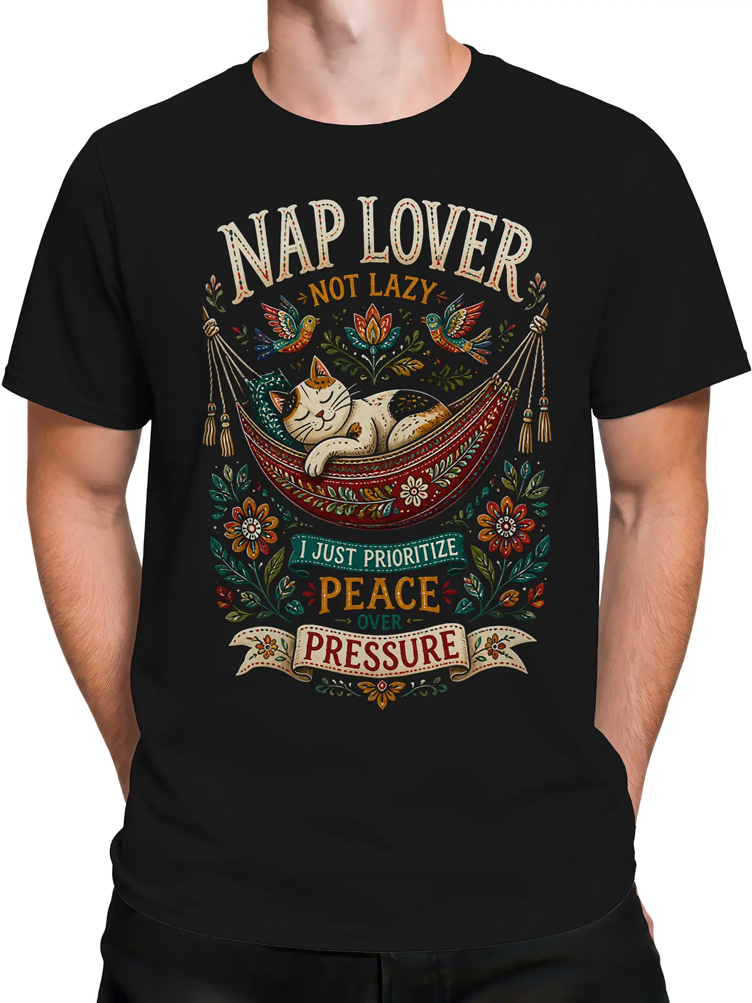 Male torso wearing a black cat T-shirt with a sleeping hammock cat and colorful folk art print