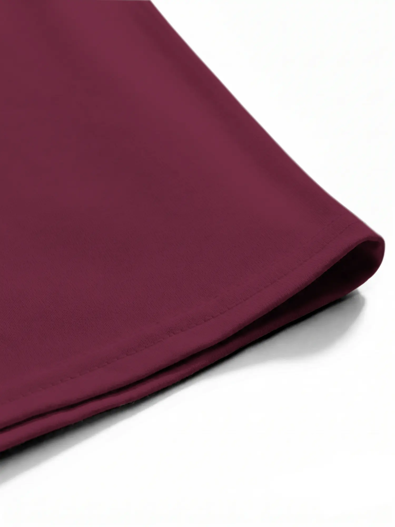 Close-up of burgundy T-shirt hem stitching and cotton fabric