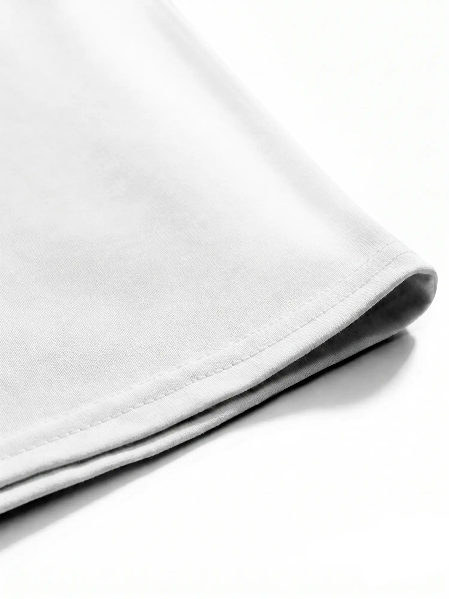 Close-up of white cotton T-shirt hem and stitching with neat finished construction