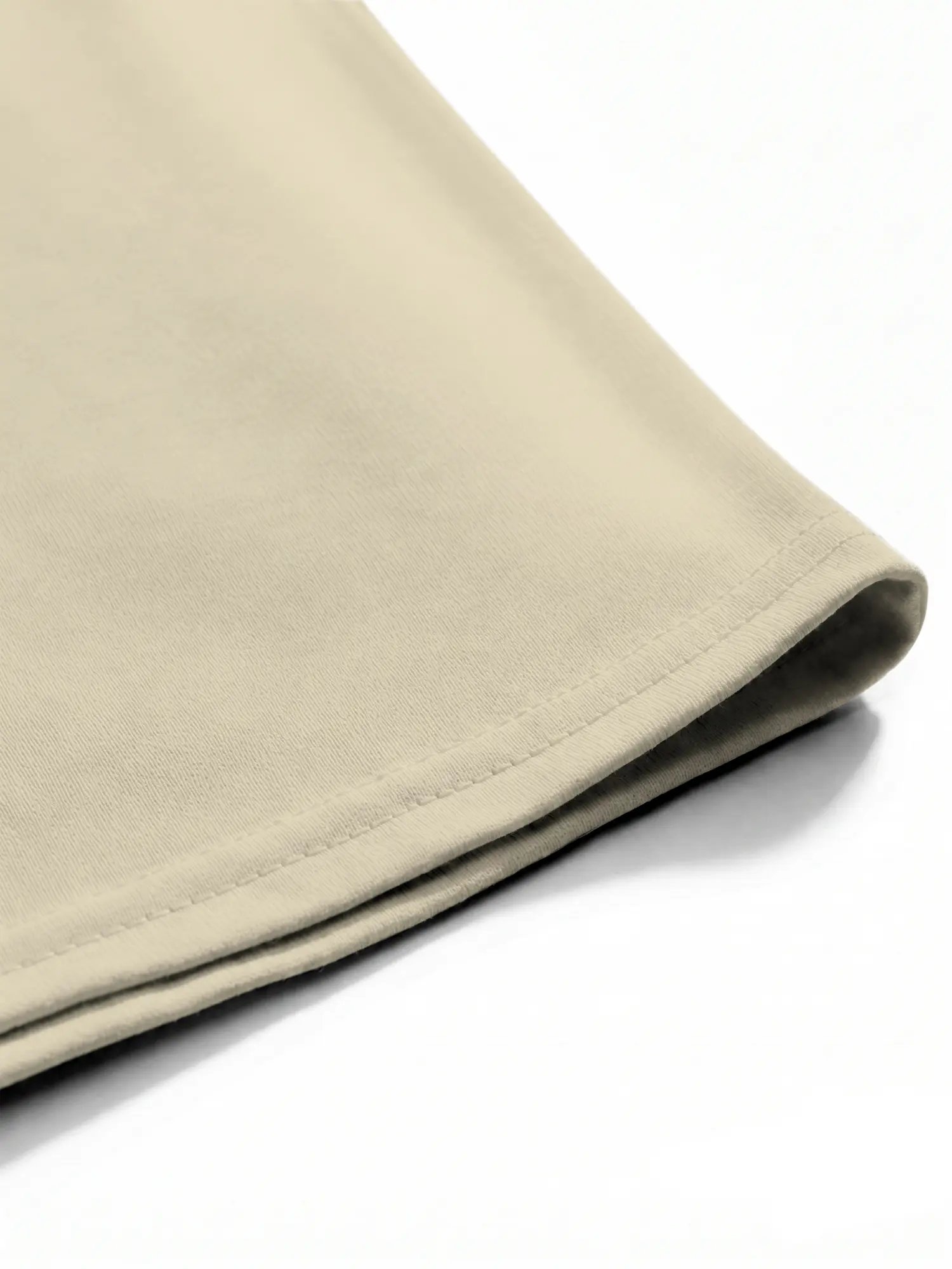Beige cotton shirt hem and stitching shown in a detailed construction close-up