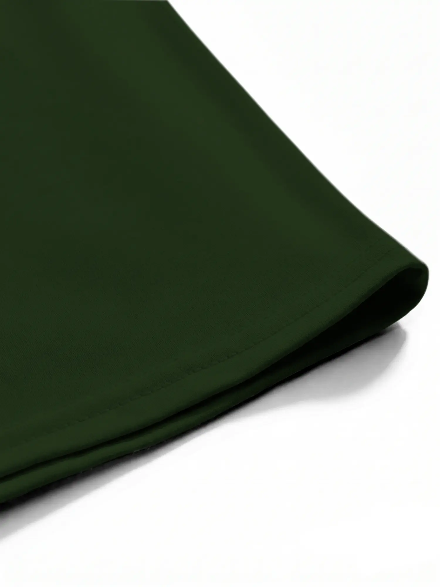 Close-up of green cotton shirt hem and stitching details