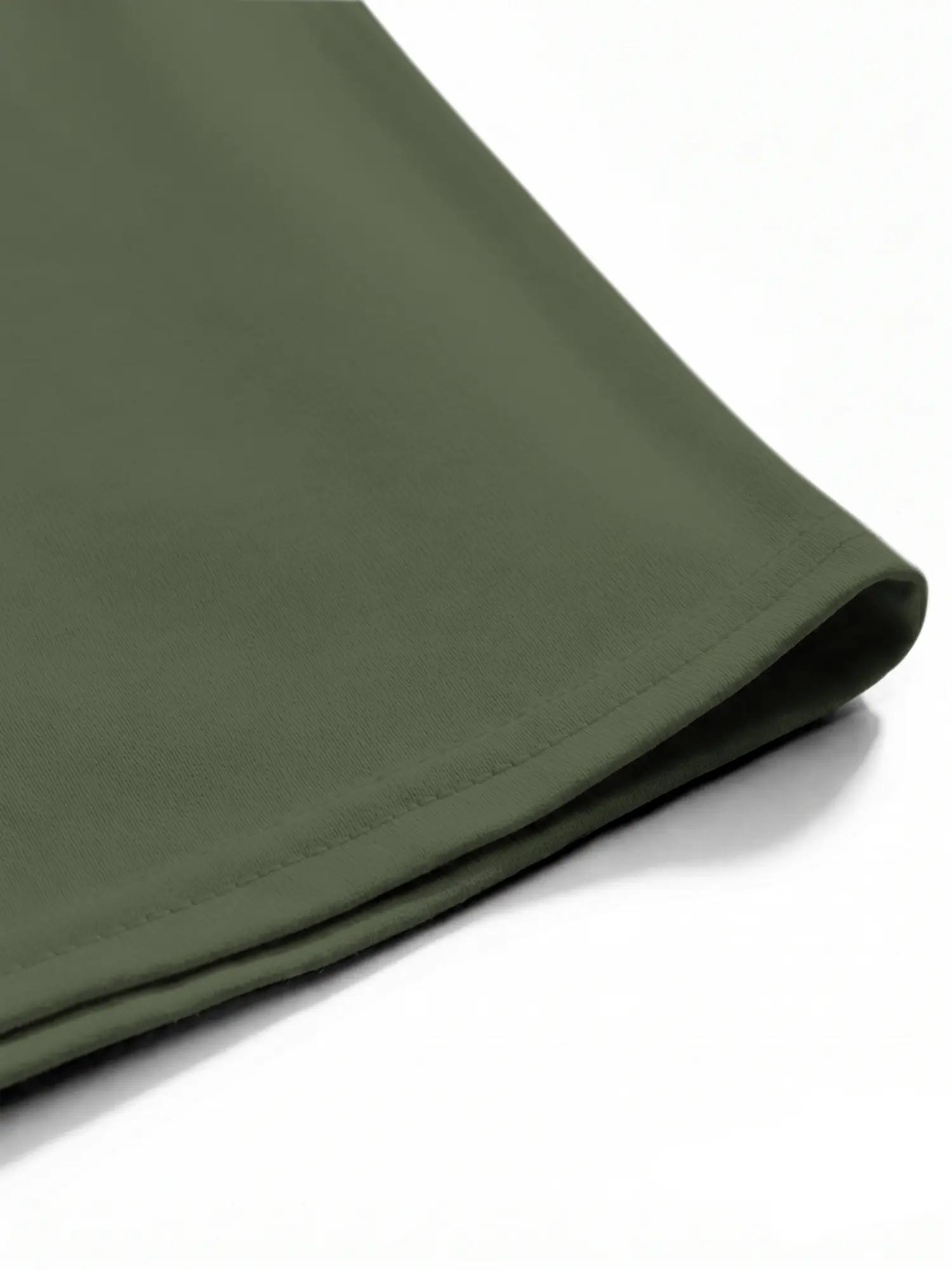 Green cotton shirt hem with neat stitching and smooth fabric detail