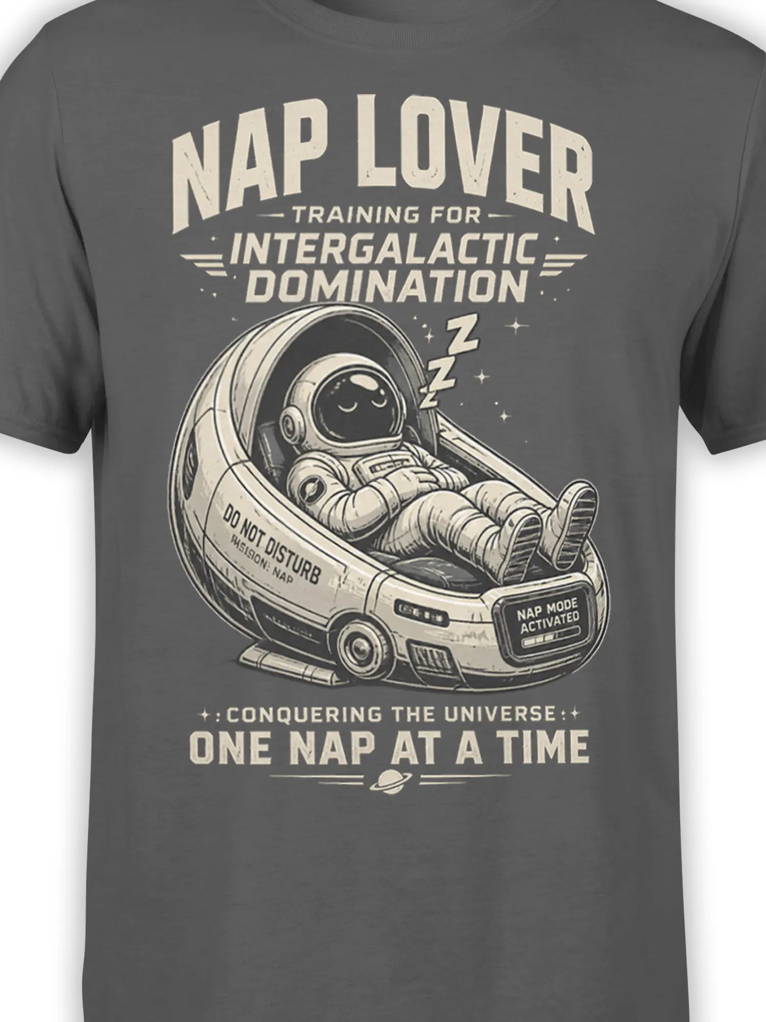 Close-up of sleeping astronaut in a space pod with “Nap Mode Activated” text on gray fabric