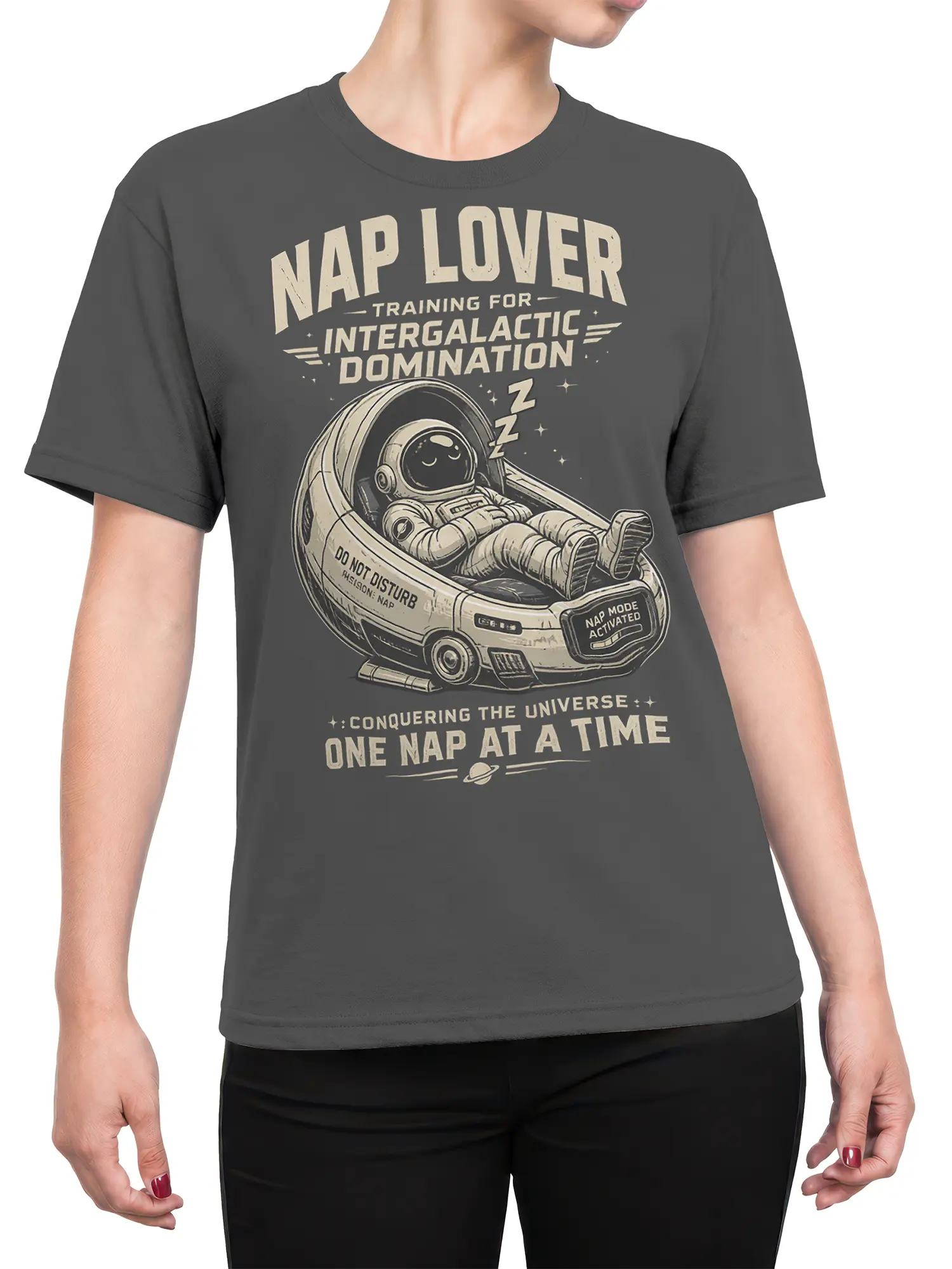 Female torso wearing gray astronaut T-shirt with sleeping space traveler and intergalactic nap graphics