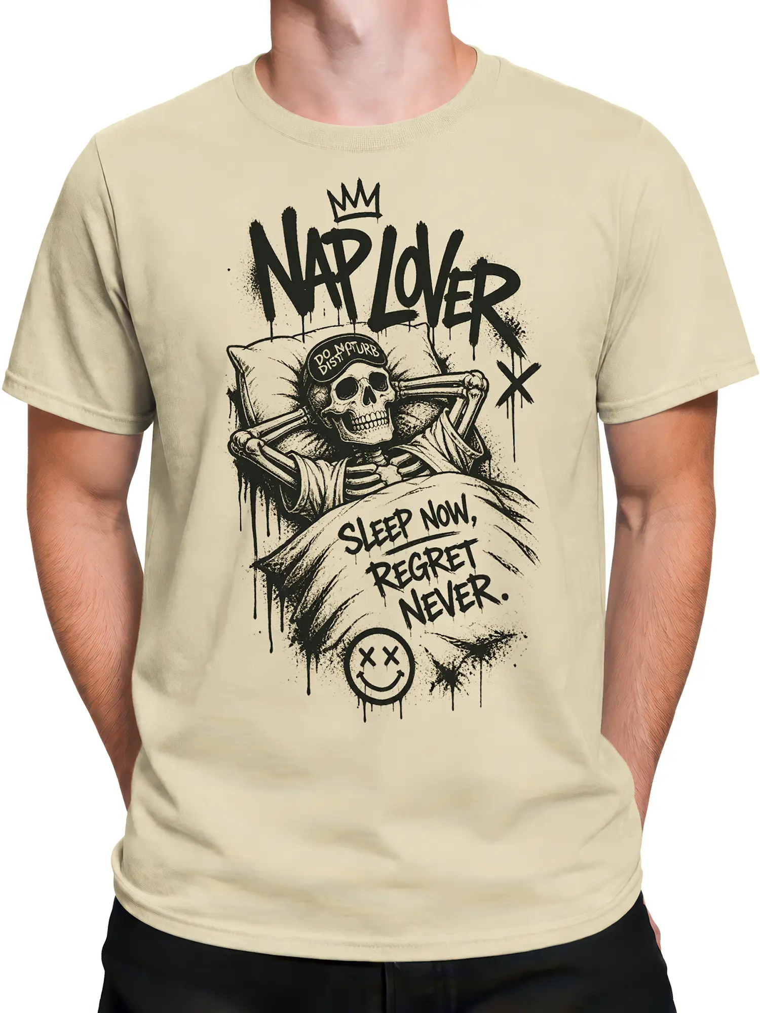Male torso wearing a beige skull T-shirt with a sleeping skeleton, crown, and do not disturb message