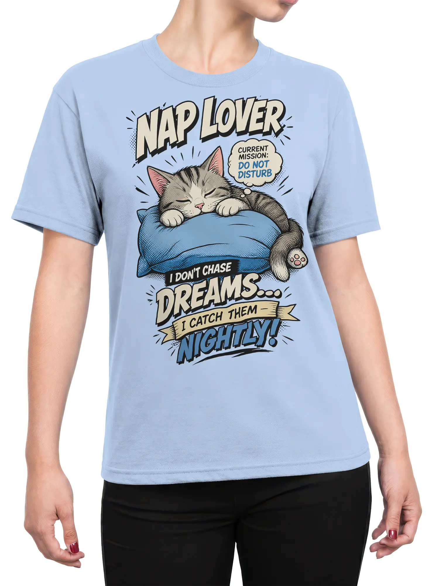Female torso wearing a light blue cat T-shirt with a sleepy tabby, pillow, and nightly dreams message