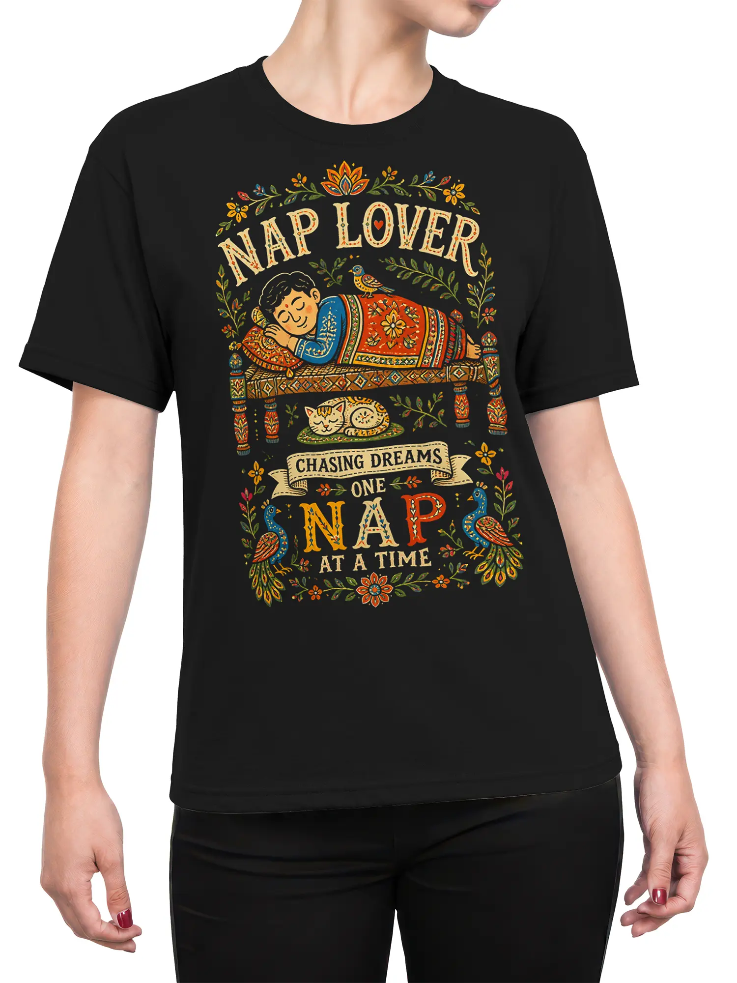 Female torso wearing a black nap lover T-shirt with colorful folk art artwork and dream-themed lettering