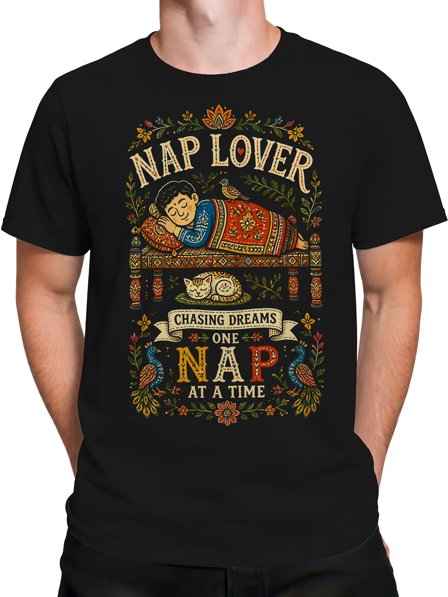 Male torso wearing a black nap lover T-shirt with colorful folk art artwork and dream-themed lettering
