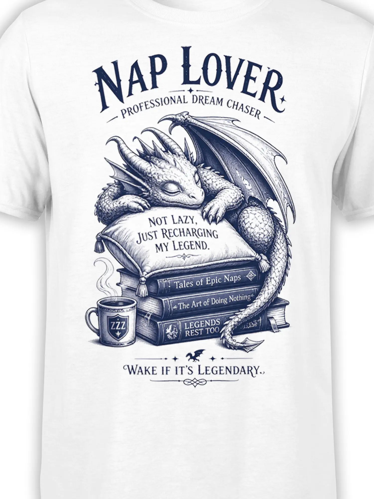 Close-up of sleeping dragon artwork, pillow, books, coffee mug, and lettering on a white T-shirt