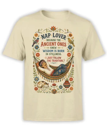 Beige cat T-shirt with a vintage folk-art hammock scene, sleeping figure, birds, flowers, and a nap wisdom quote