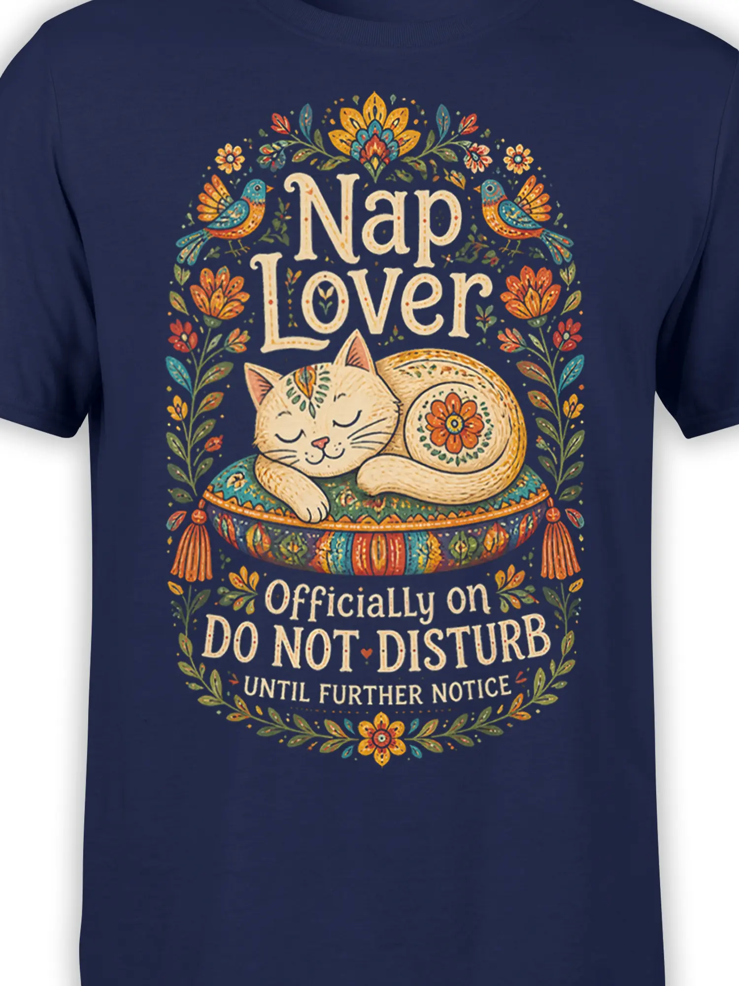 Close-up of sleeping cat, folk-style flowers, decorative cushion, and Nap Lover text on navy fabric