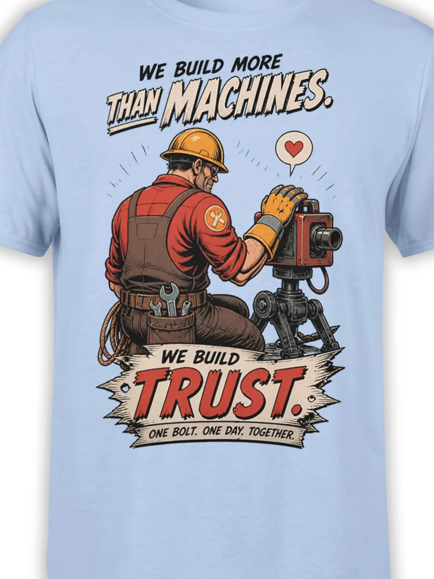 Close-up of construction worker artwork, hard hat, tools, machine, and trust message on a light blue T-shirt
