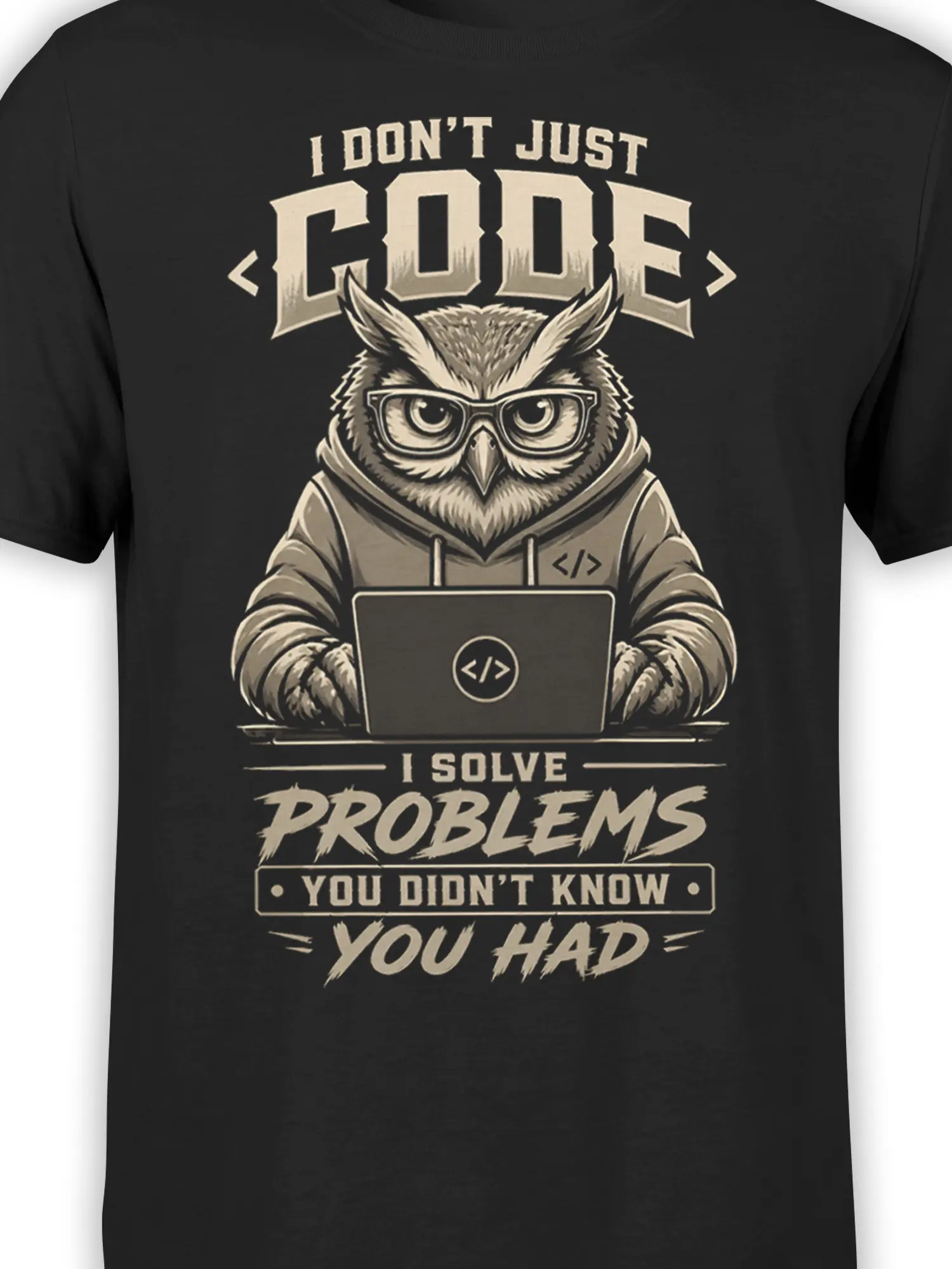 Close-up of owl programmer artwork on a black shirt with glasses, laptop, coding symbols, and cream lettering