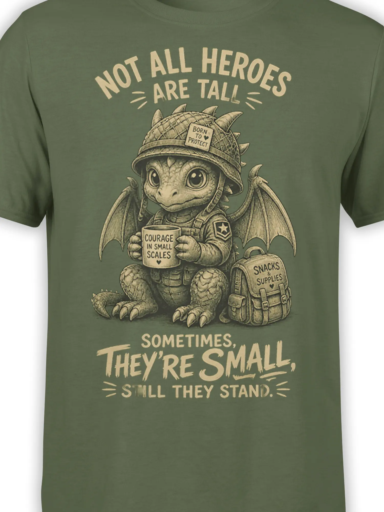 Close-up of small dragon hero artwork with helmet, wings, courage mug, and supplies on green fabric