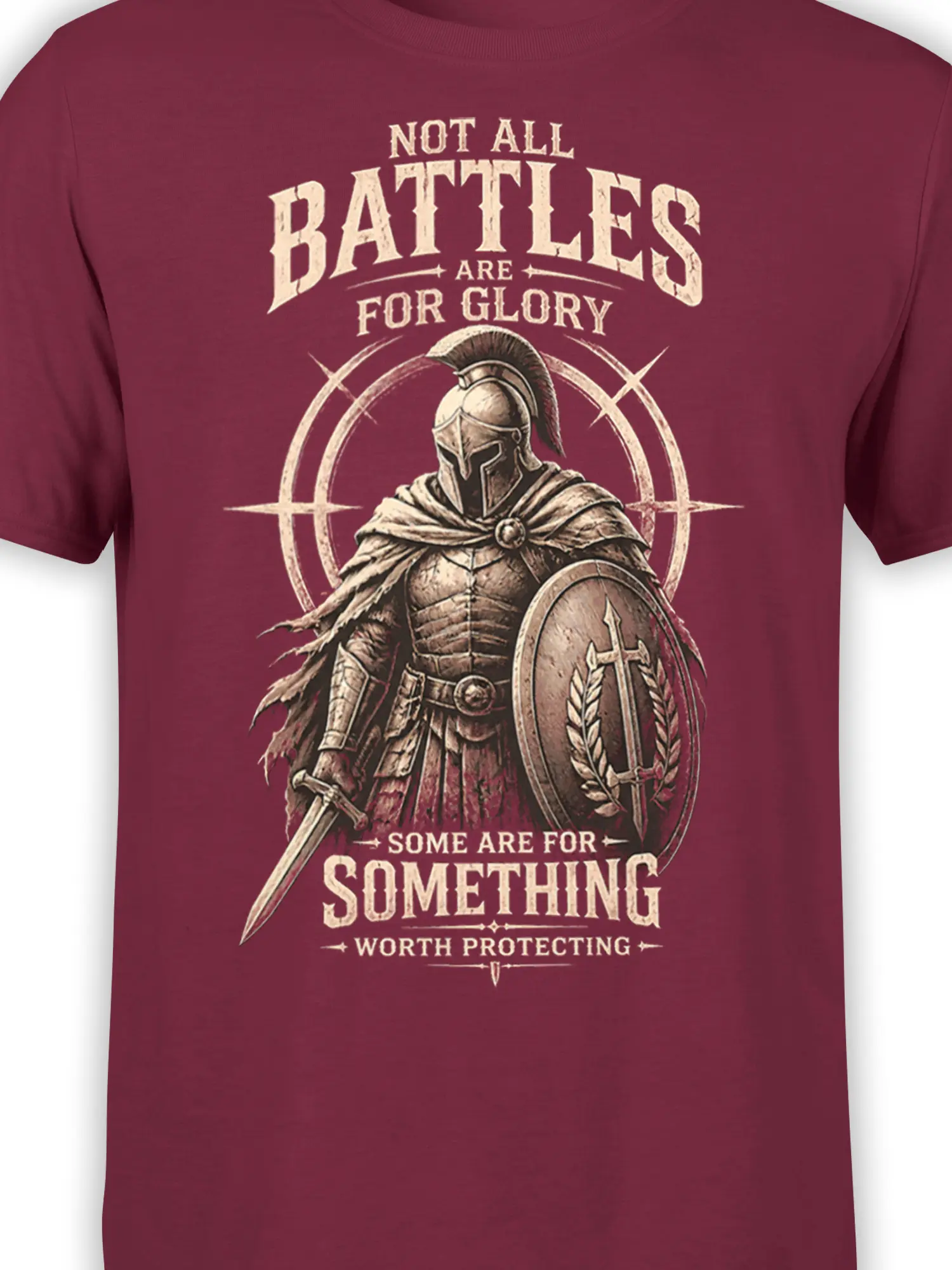 Close-up of Roman warrior artwork, shield, sword, and cream lettering on a burgundy T-shirt