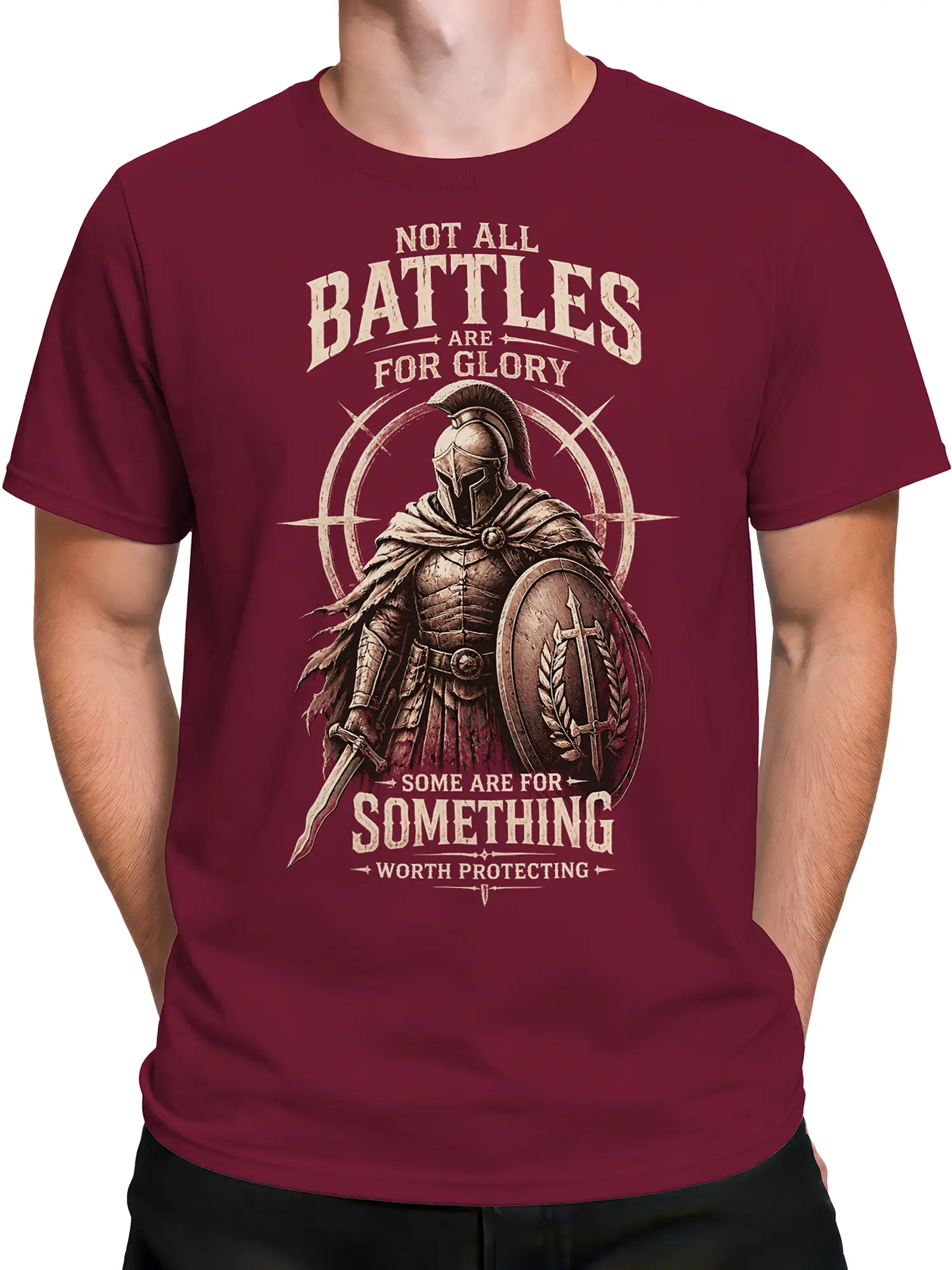 Male torso wearing a burgundy Roman warrior T-shirt with shield, sword, and bold cream lettering